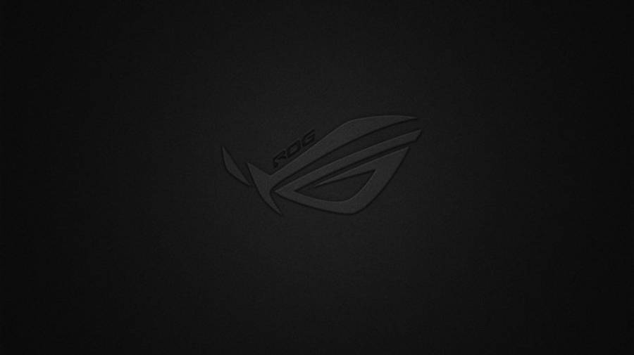 黑色 桌布 壁紙 — 一個極簡的深灰色 ROG 標誌，微妙地壓印在有紋理的黑色背景上。