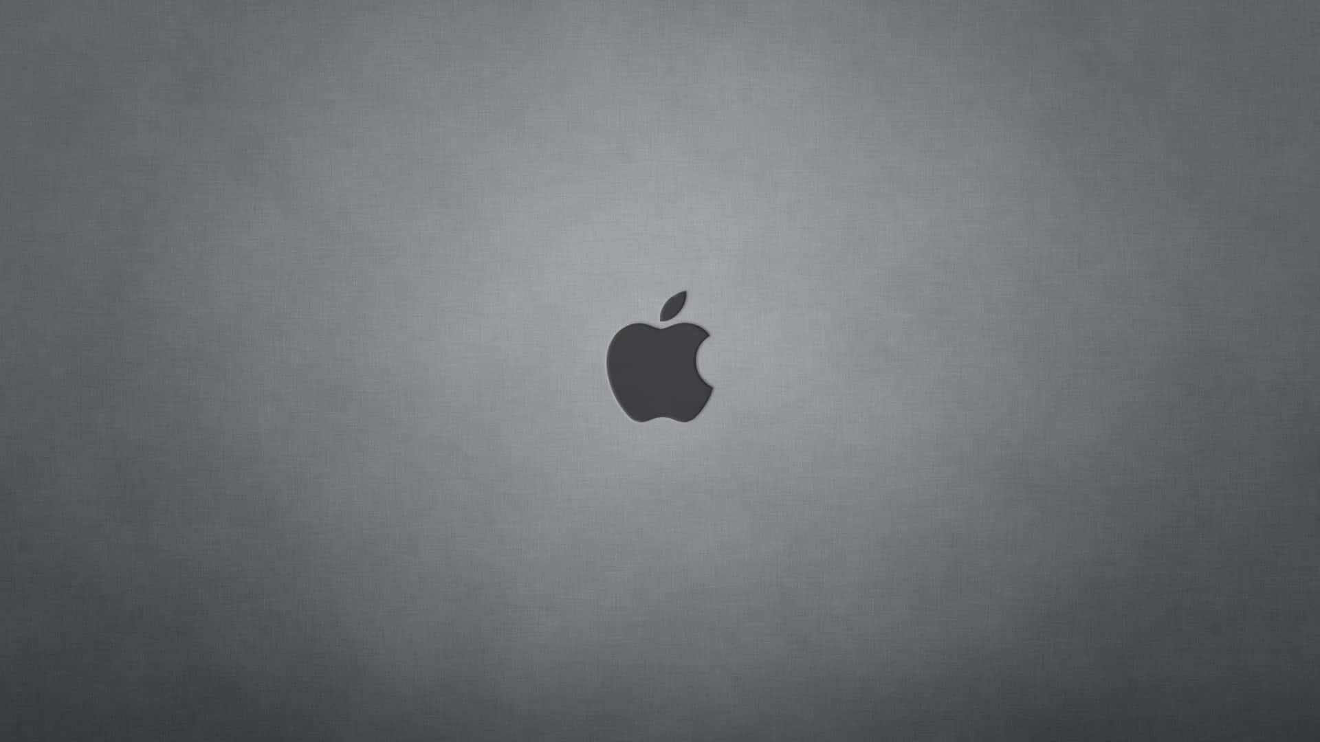 Black Macbook 桌布 壁紙 — 一個極簡的深灰色Apple標誌，居中放置在帶有微妙紋理的漸變背景上。