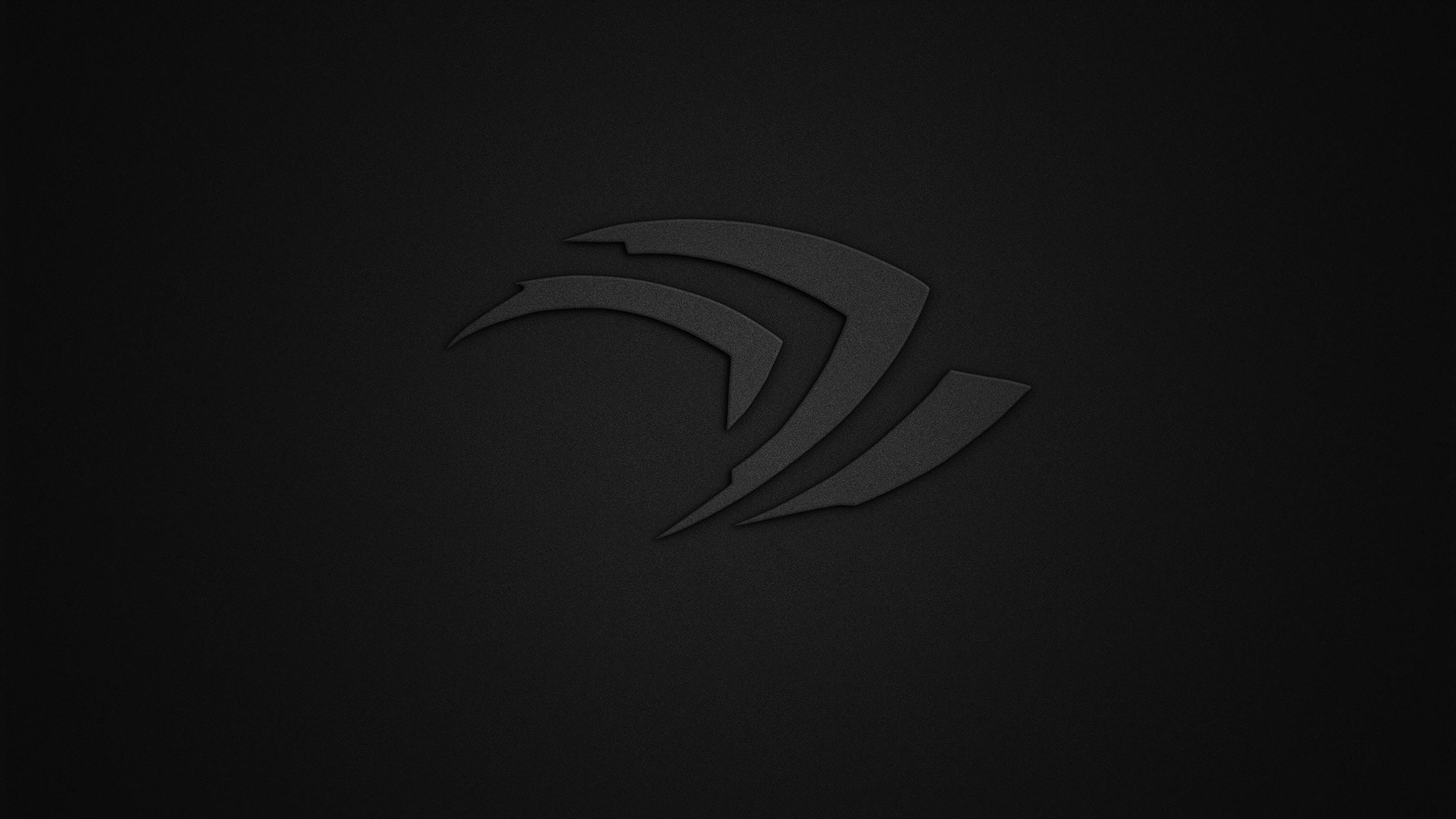 nvidia 桌布 壁紙 — 一個極簡的深灰色NVIDIA標誌，微妙地壓印在帶紋理的黑色背景上。