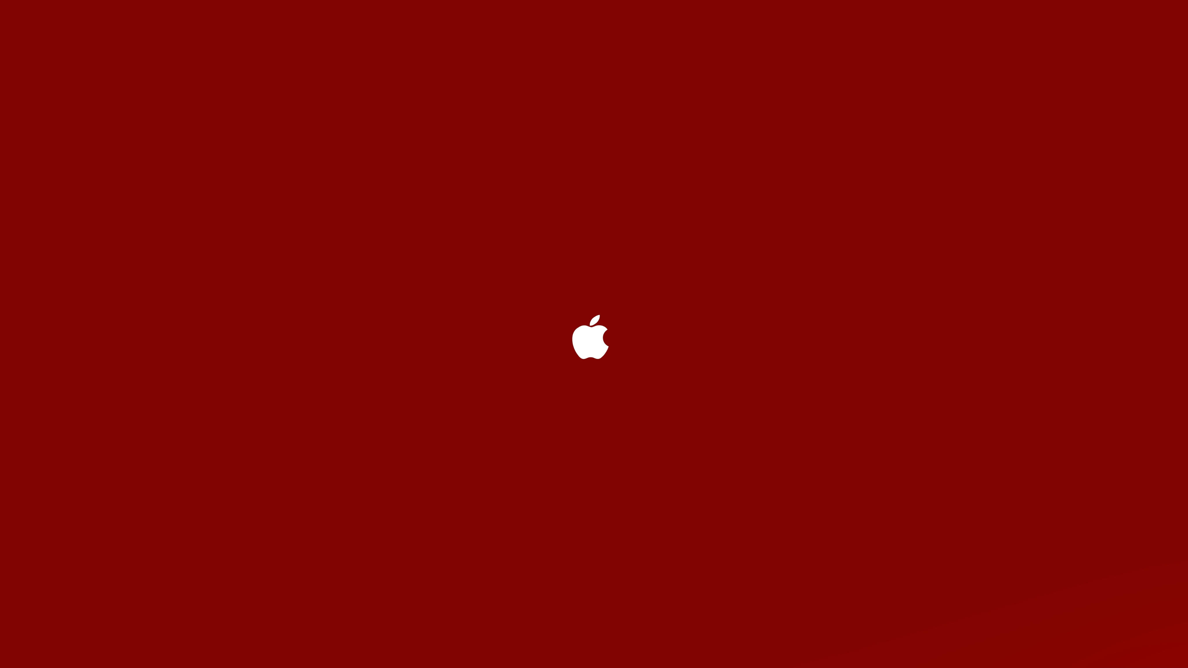 Apple 4K Ultra HD 桌布 壁紙 — 一個極簡的白色Apple標誌，居中放置在純深紅色背景上。