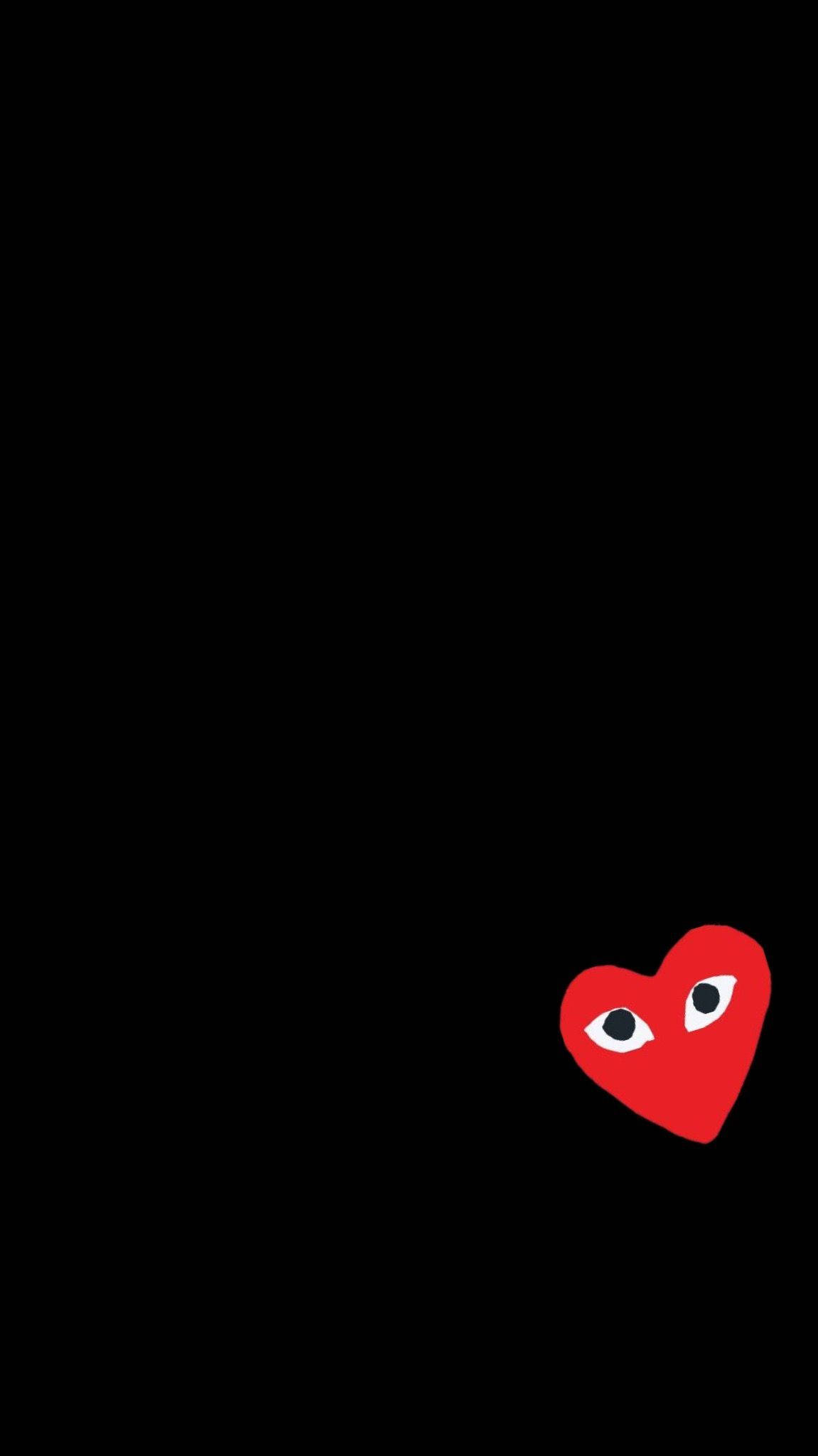 cdg 桌布 壁紙 — 一個極簡的紅色心形，帶有兩隻眼睛，從右下角窺視，背景為純黑色。