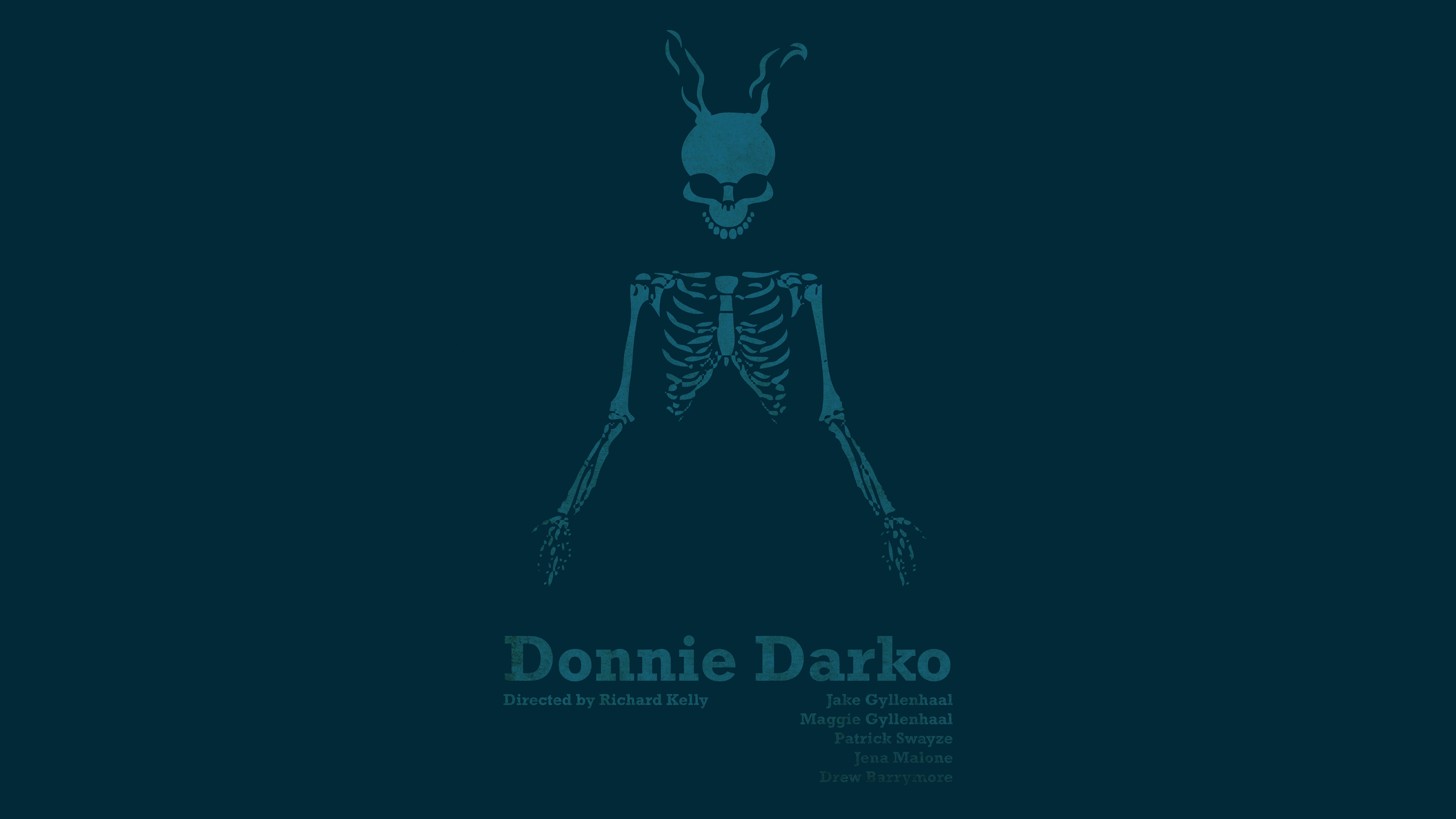 Darko 桌布 壁紙 — 一個極簡的青綠色骷髏頭戴兔耳，居中站立在深青綠色背景上，下方有電影字幕。