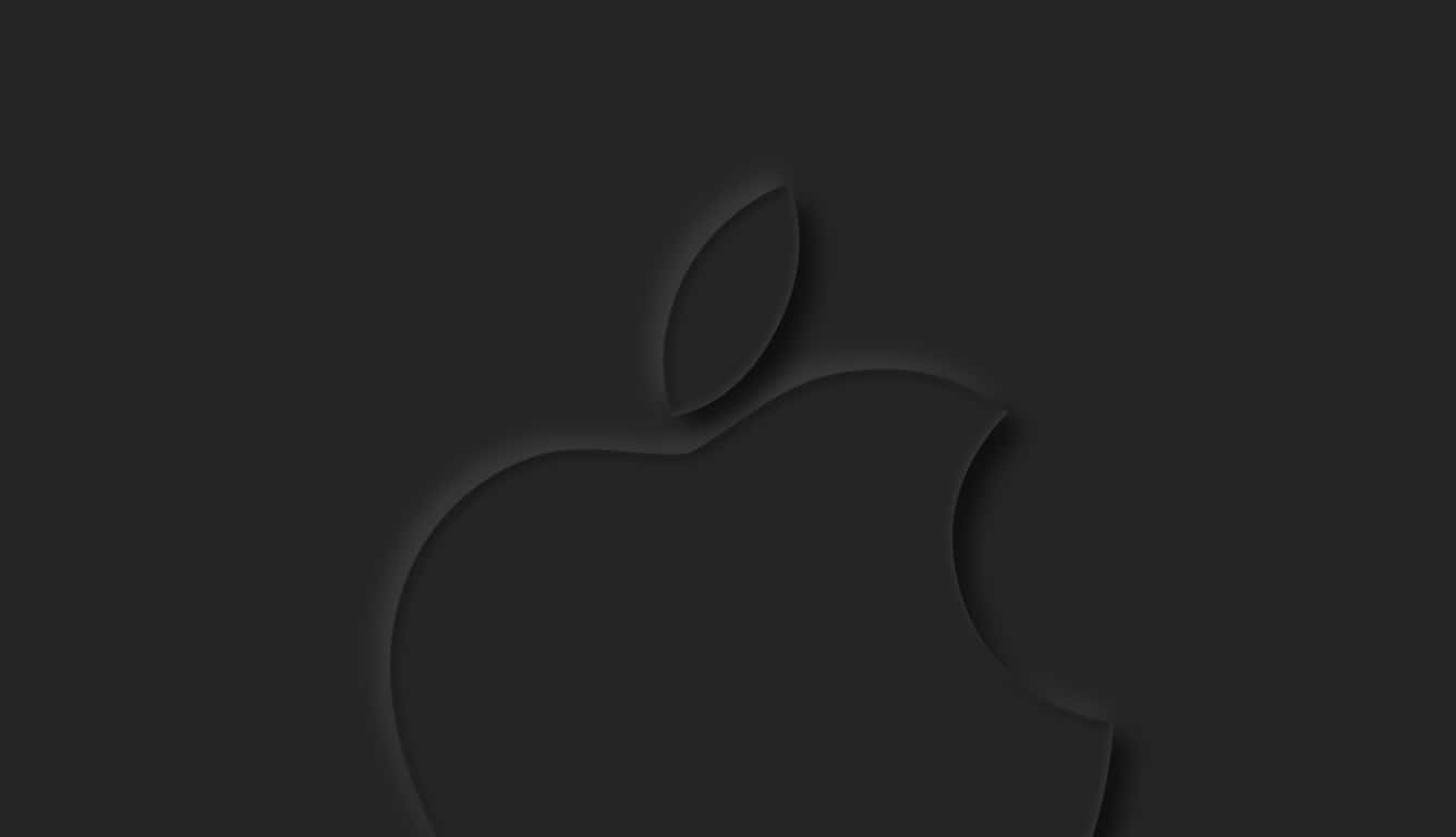 蘋果 桌布 壁紙 — 一個極簡的黑色Apple標誌，在深炭灰色背景上帶有柔和陰影深度，低調壓印。