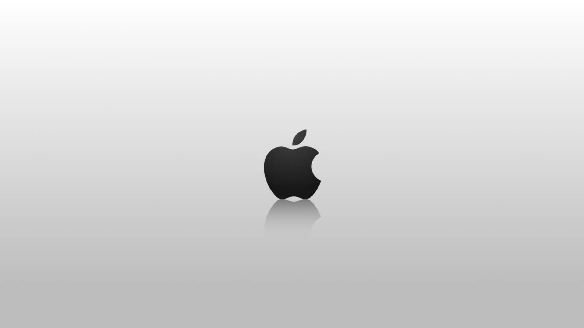 高清 桌布 壁紙 — 一個極簡的黑色Apple標誌居中於漸變灰色背景上，帶有微妙的倒影。