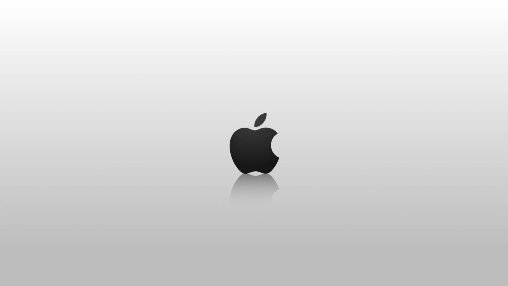 蘋果 桌布 壁紙 — 一個極簡的黑色Apple標誌居中在漸變灰色背景上，帶有微妙的反射。