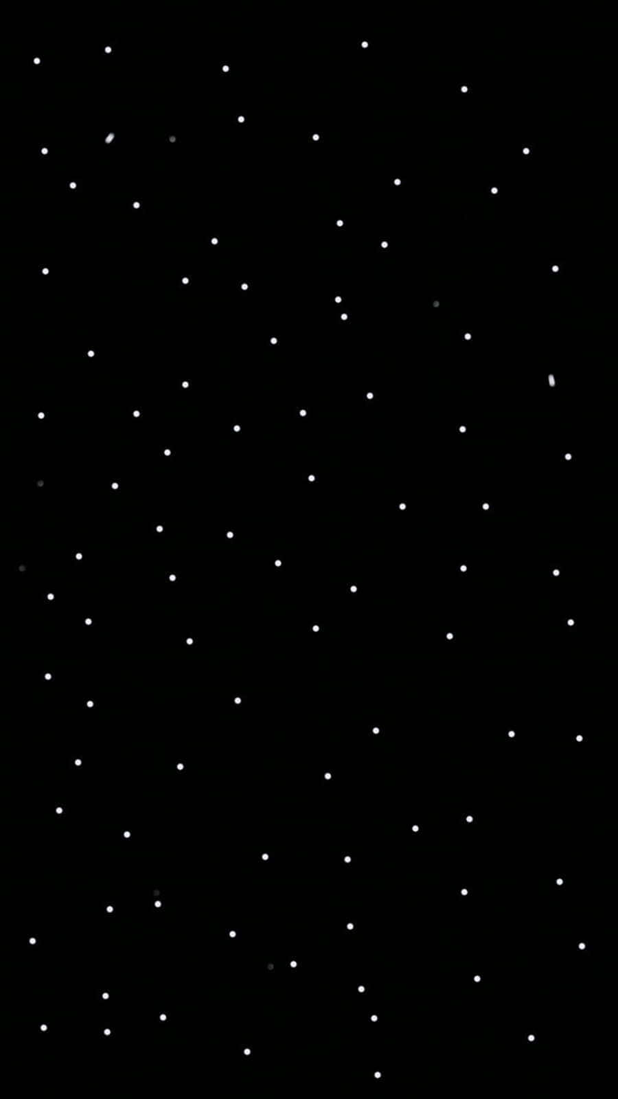 Black And White Dots 桌布 壁紙 — 一個極簡的黑色背景，點綴著散落的白色星星，營造出寧靜的宇宙夜空。