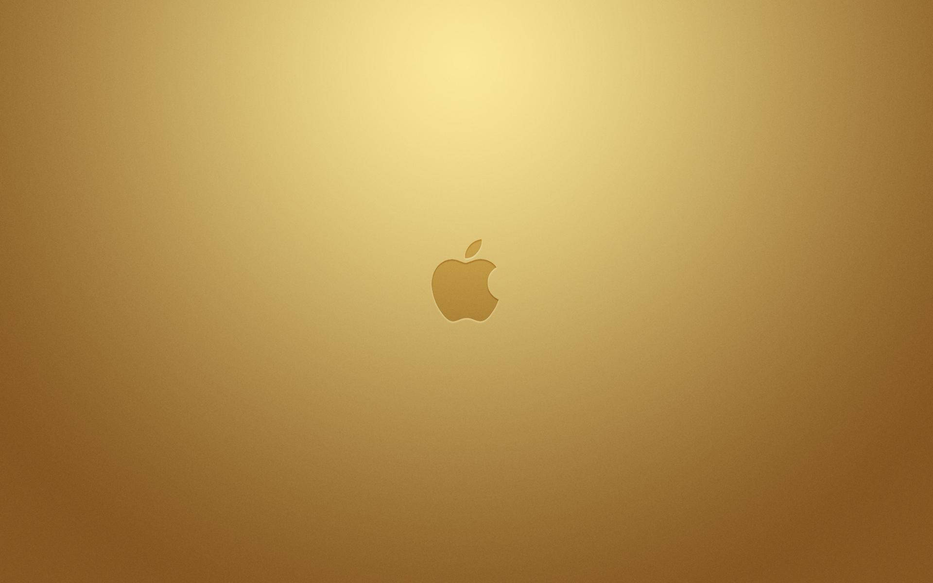 蘋果 桌布 壁紙 — 一個極簡金色Apple標誌居中於柔和漸變金色背景上。