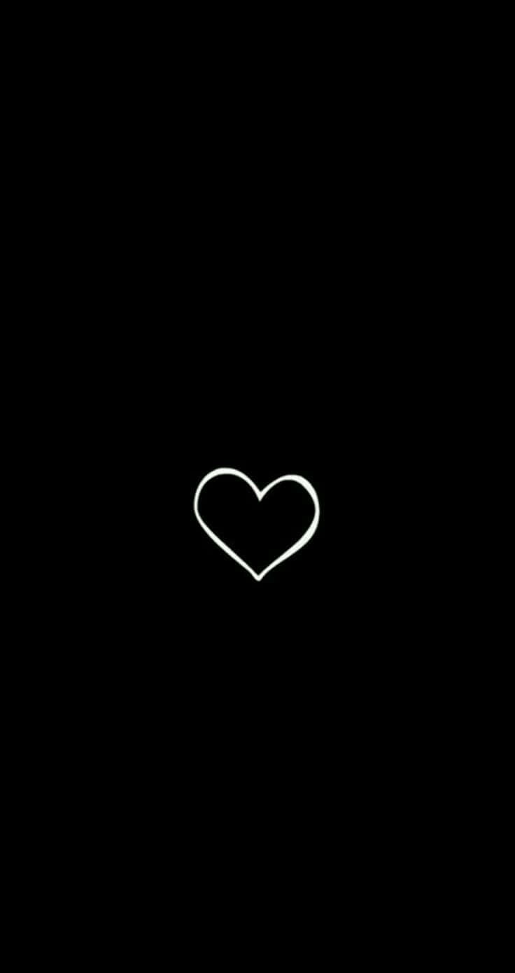 Black Heart Aesthetic 桌布 壁紙 — 一個極簡風格的白色心形輪廓，居中於純黑色背景上。