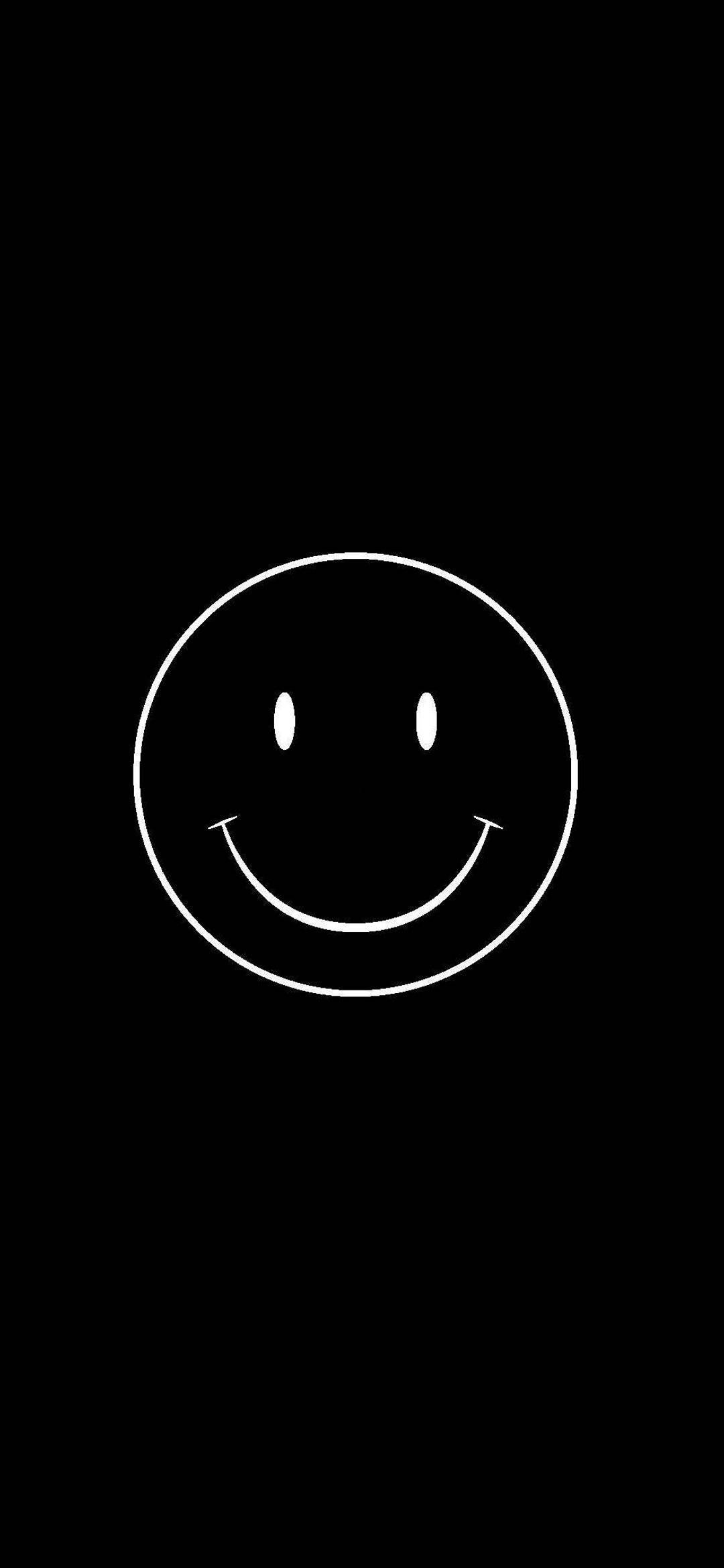 Smiley 桌布 壁紙 — 一個極簡風格的白色線條笑臉，居中於純黑色背景上。