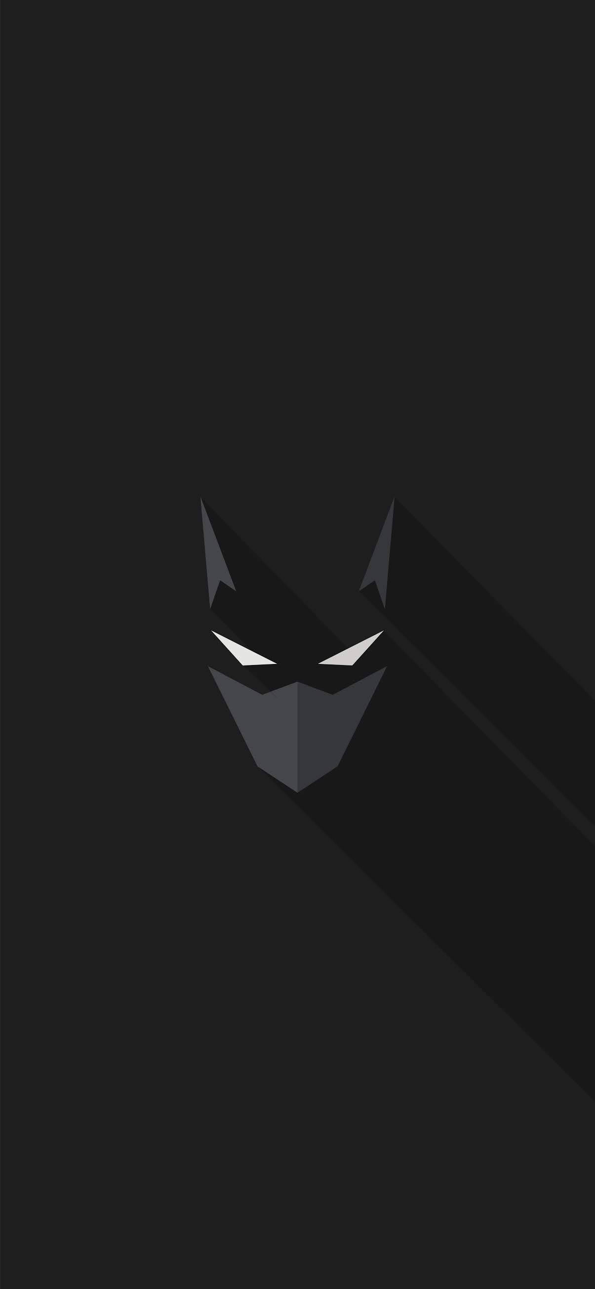 The Batman iPhone 桌布 壁紙 — 一個極簡風格的蝙蝠俠面具，帶有銳利的白色眼睛，在純黑背景上投下長長的陰影。