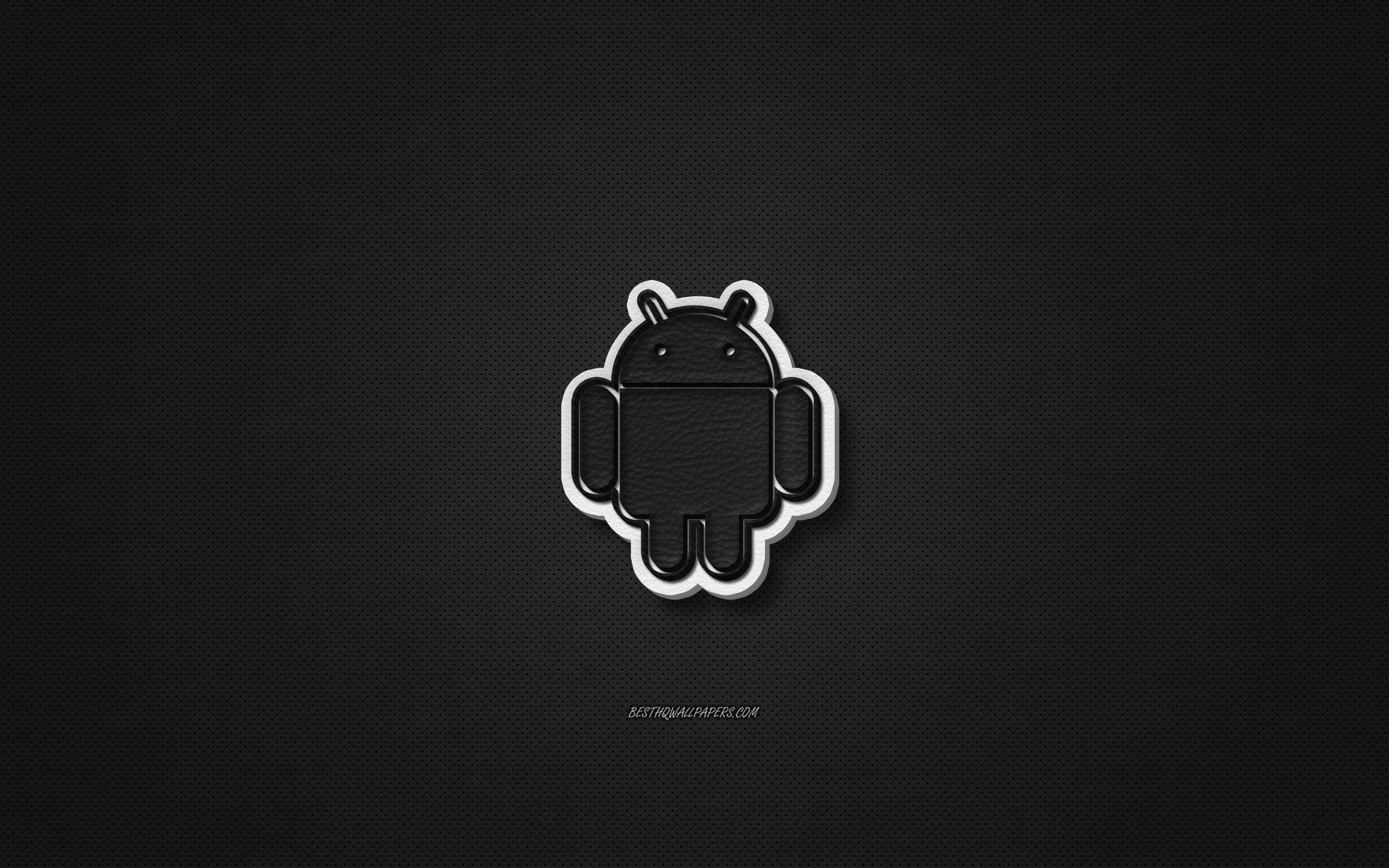 Android Desktop 桌布 壁紙 — 一個極簡風格的黑色Android機器人標誌，帶有白色輪廓，居中放置在帶紋理的深色背景上。