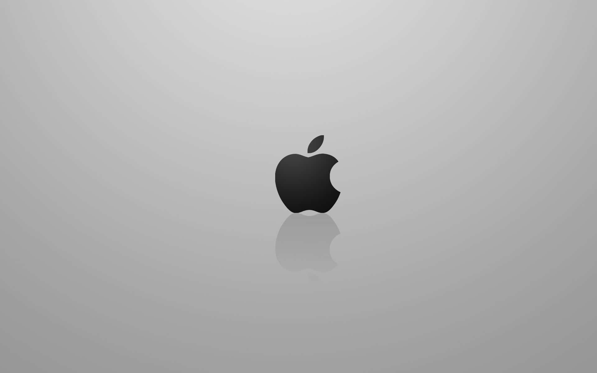 Mac 桌布 壁紙 — 一個極簡風格的黑色Apple標誌，帶有倒影，居中放置在漸變灰色背景上。