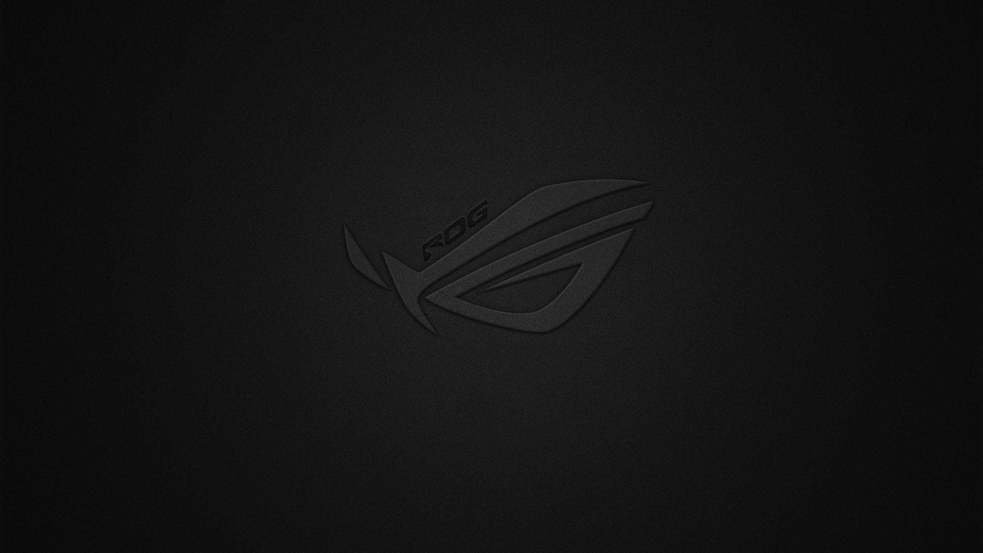 Rog 桌布 壁紙 — 一個極簡風格的黑色ROG標誌，微妙地壓印在有紋理的深色背景上。