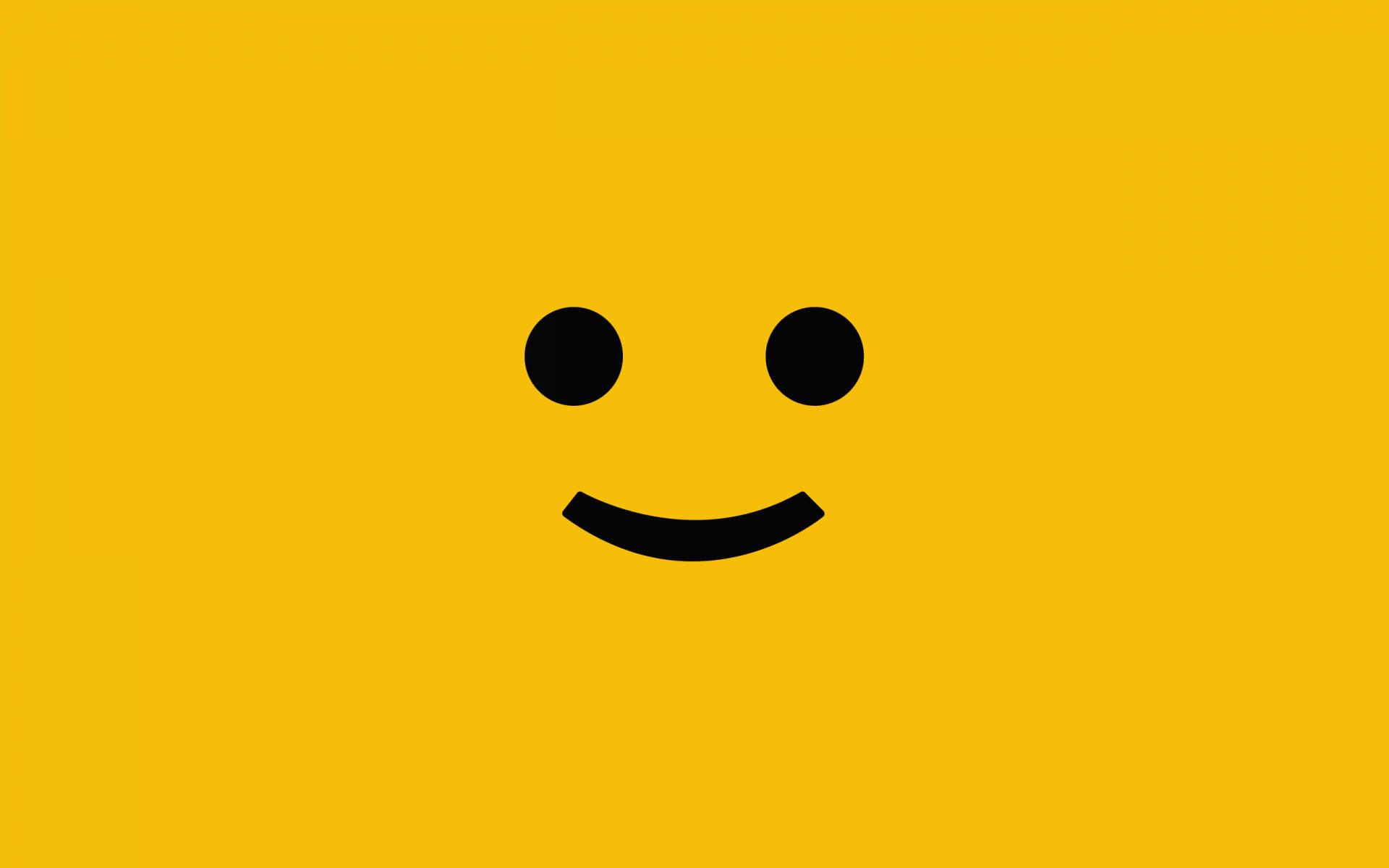 笑臉 桌布 壁紙 — 一個極簡風格的黑色笑臉，有兩點作為眼睛和彎曲的嘴巴，居中在純黃色背景上。