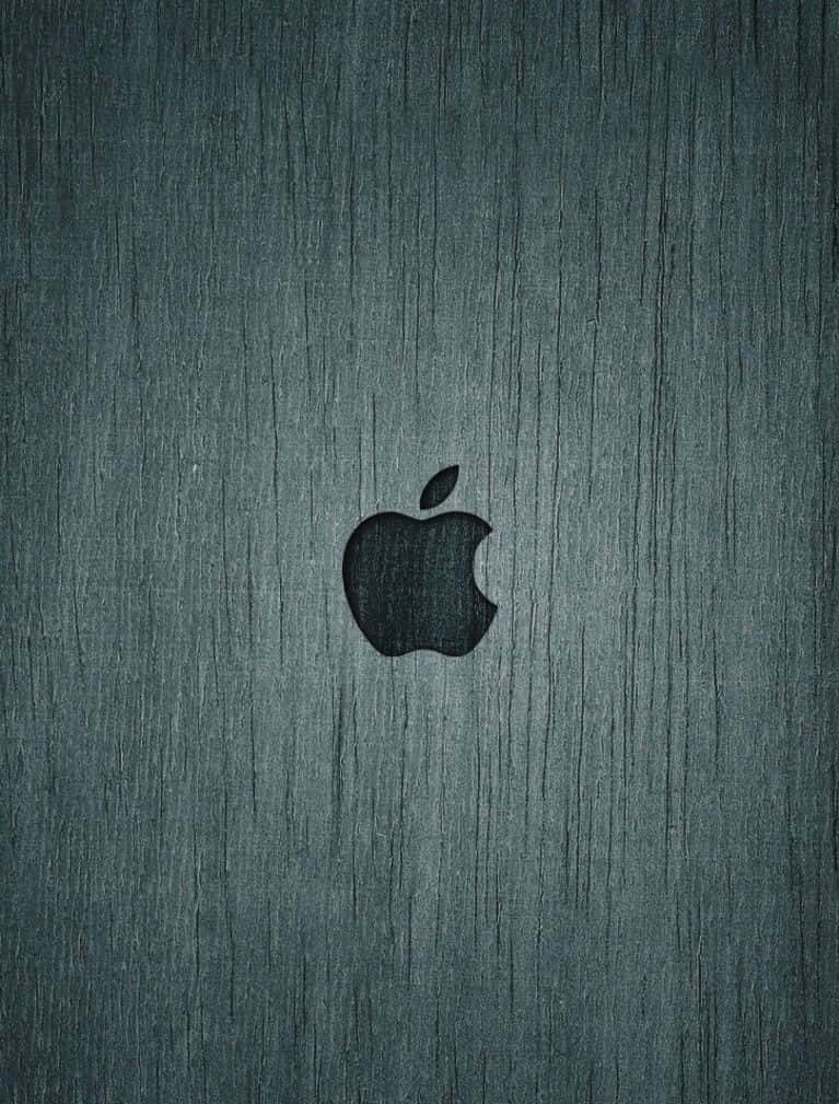木紋 桌布 壁紙 — 一個極簡黑色Apple標誌，居中於帶紋理的深青綠色拉絲金屬表面。
