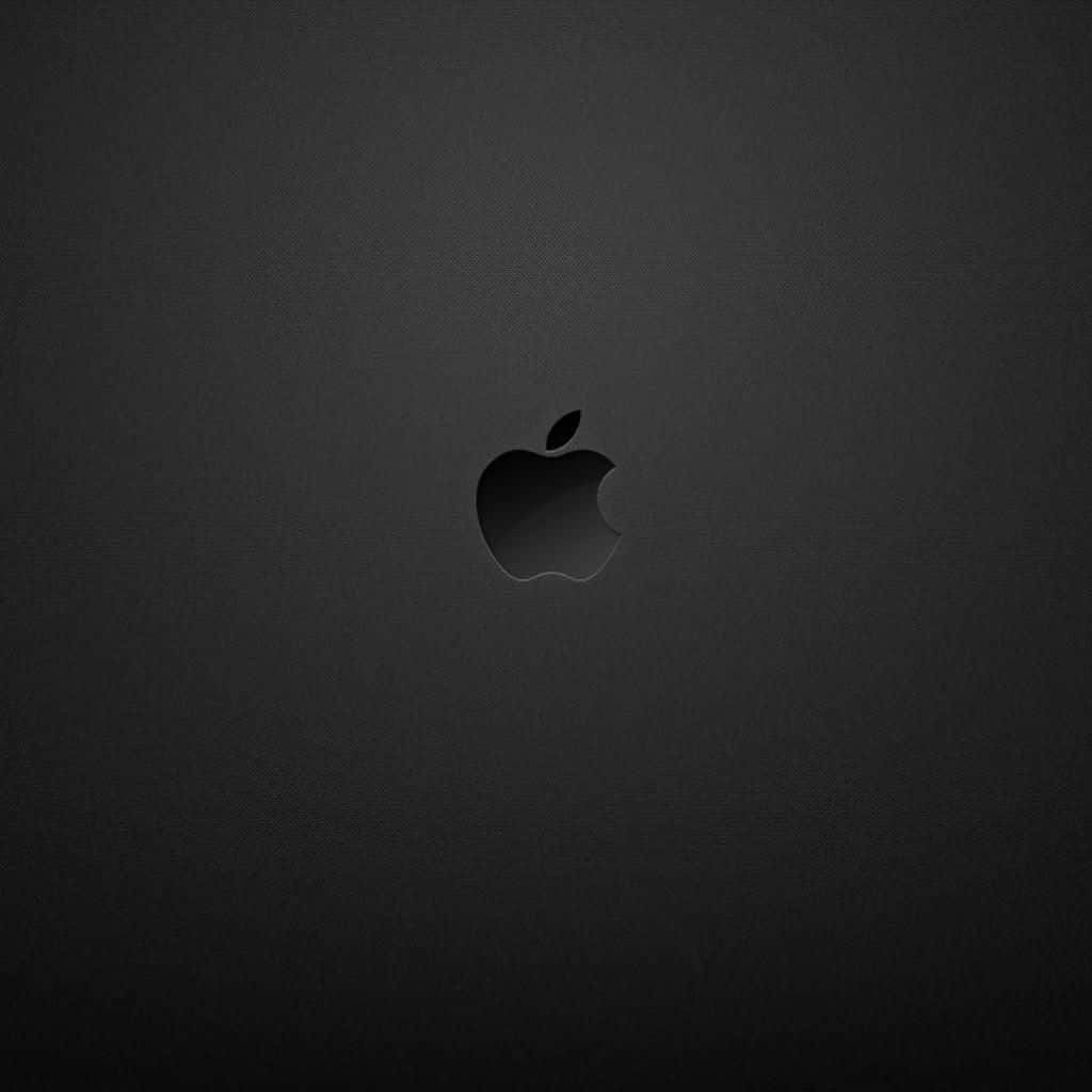 蘋果 桌布 壁紙 — 一個極簡黑色Apple標誌，居中於帶有柔和漸變照明的細微紋理深灰色背景上。