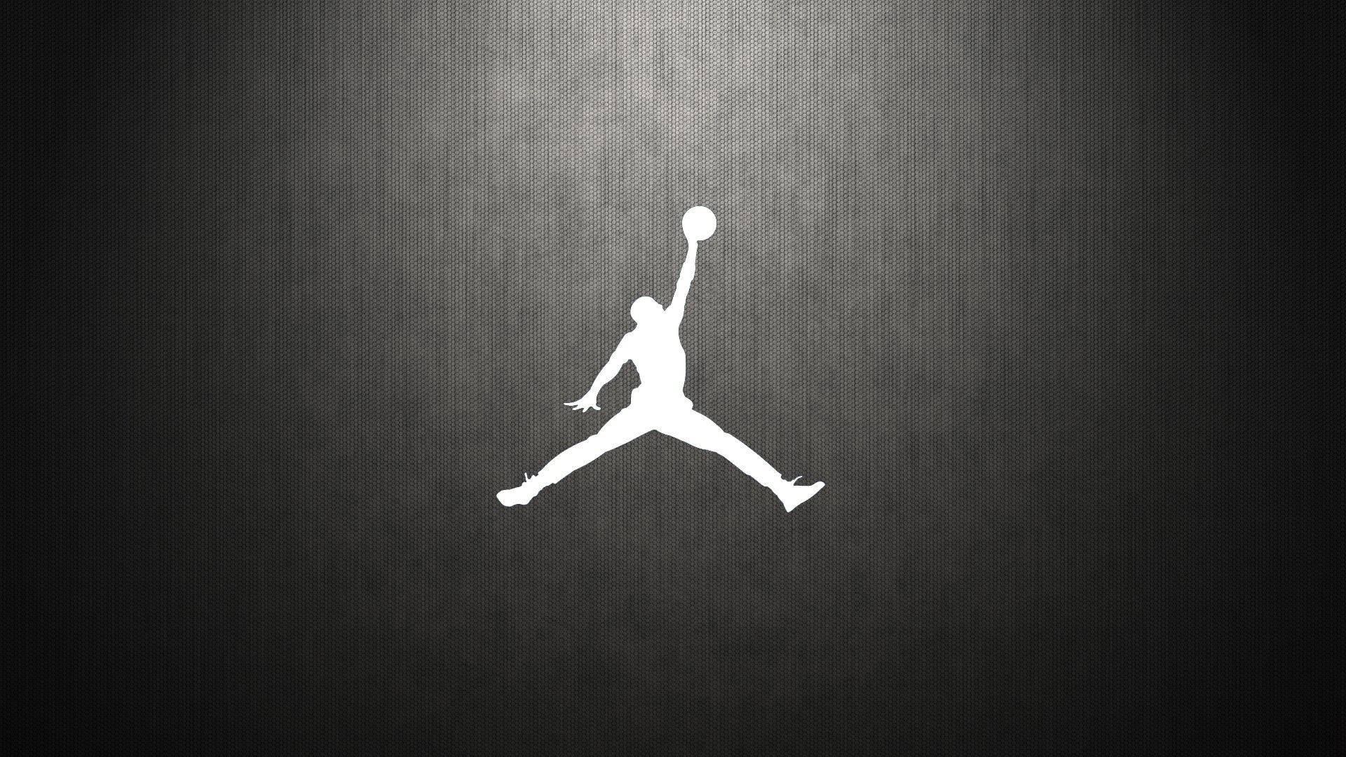 Jordan Logo 桌布 壁紙 — 一個標誌性Jordan標誌在空中的清晰白色剪影，襯托著有紋理的深灰色背景。