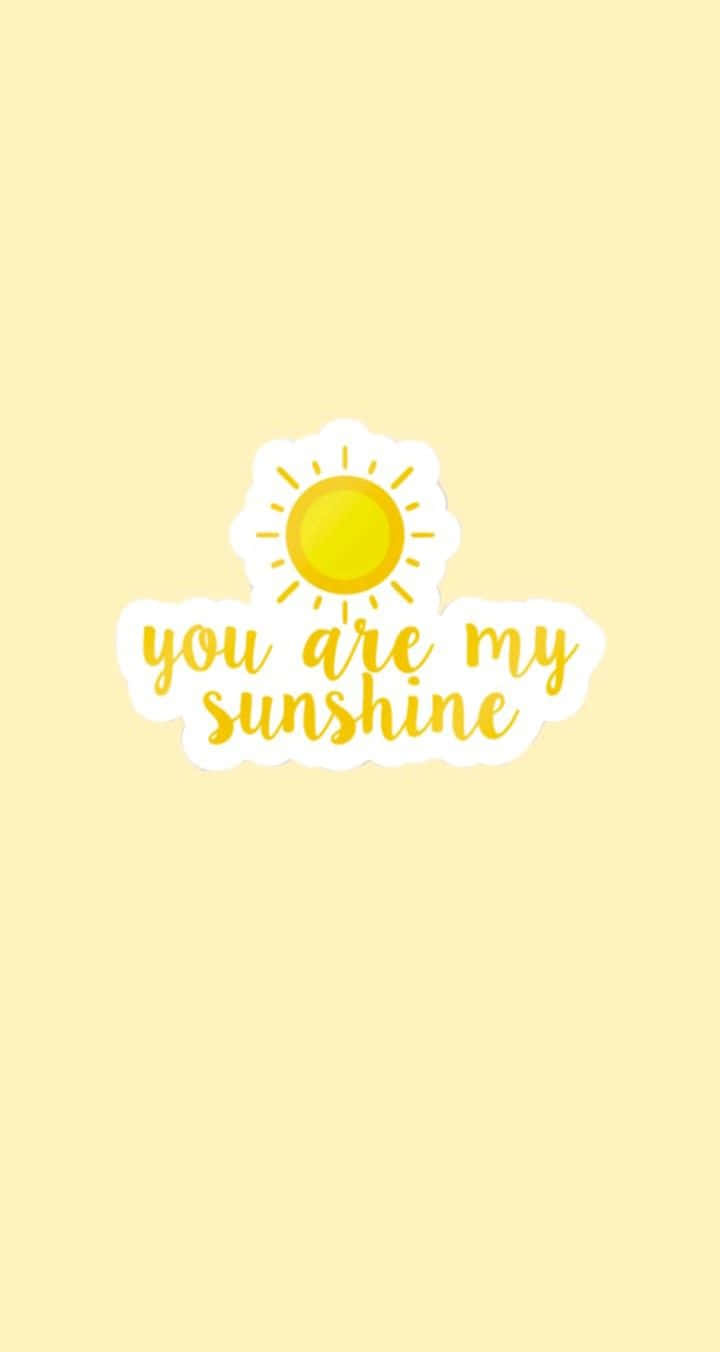 桌布 壁紙 — 一個歡快的黃色太陽圖標，上面有 you are my sunshine 的匹配字體，背景為柔和的奶油色。