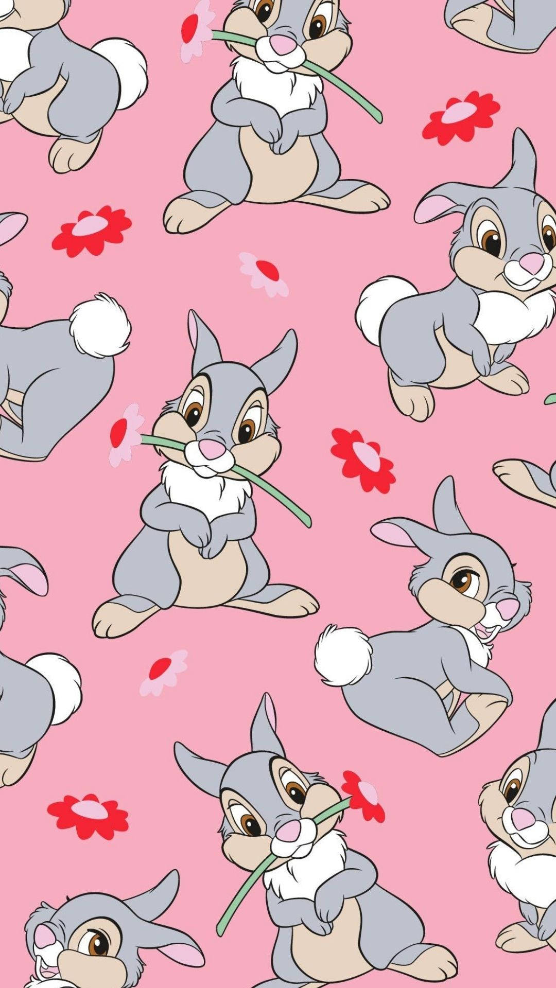 Thumper 桌布 壁紙 — 一個歡樂的圖案，卡通兔子拿著草和紅花，背景為粉紅色。