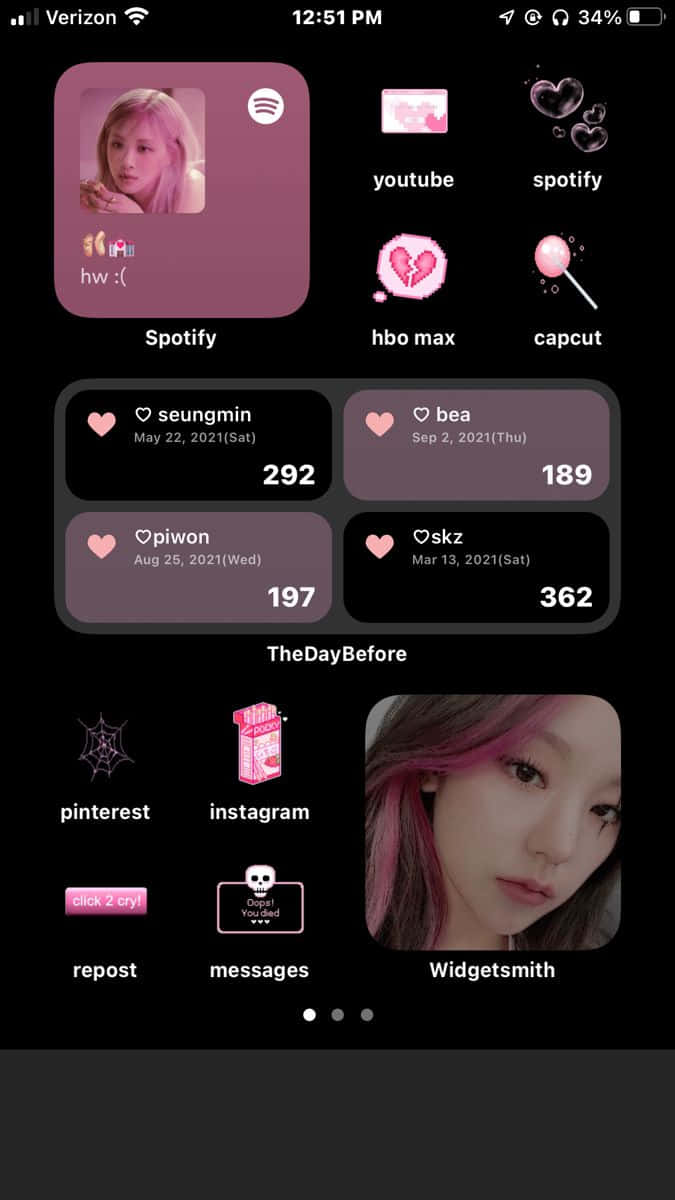 Aesthetic Widgets 桌布 壁紙 — 一個深色智慧型手機主螢幕，帶有粉紅色應用程式圖示和一個顯示粉紅色頭髮人物的自拍小工具。