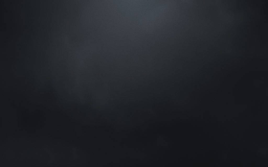 黑色 桌布 壁紙 — 一個深色紋理背景，帶有微妙的漸變和從中心向邊緣漸弱的柔和光線。