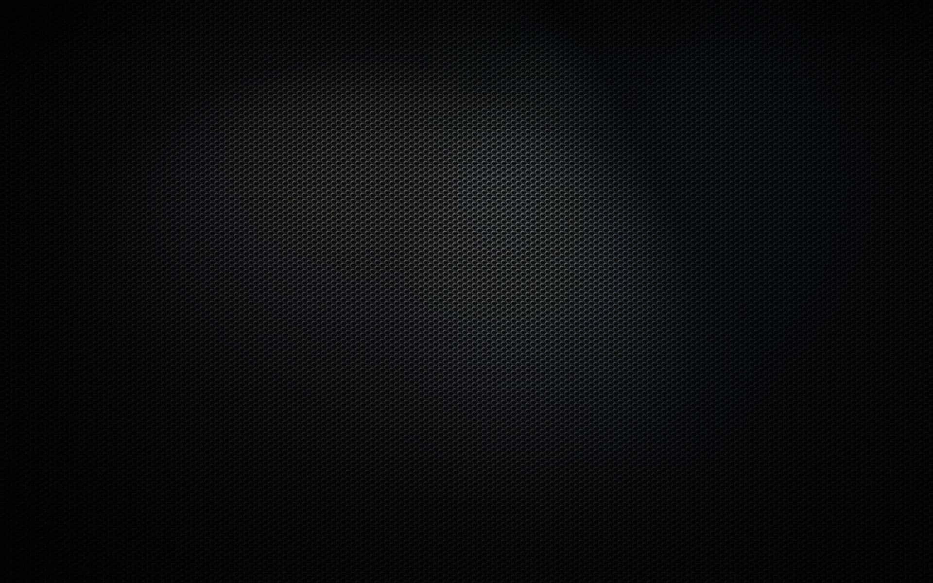 帶有柔和漸變聚光燈效果的深色紋理背景。 — 4K 黑色 壁紙