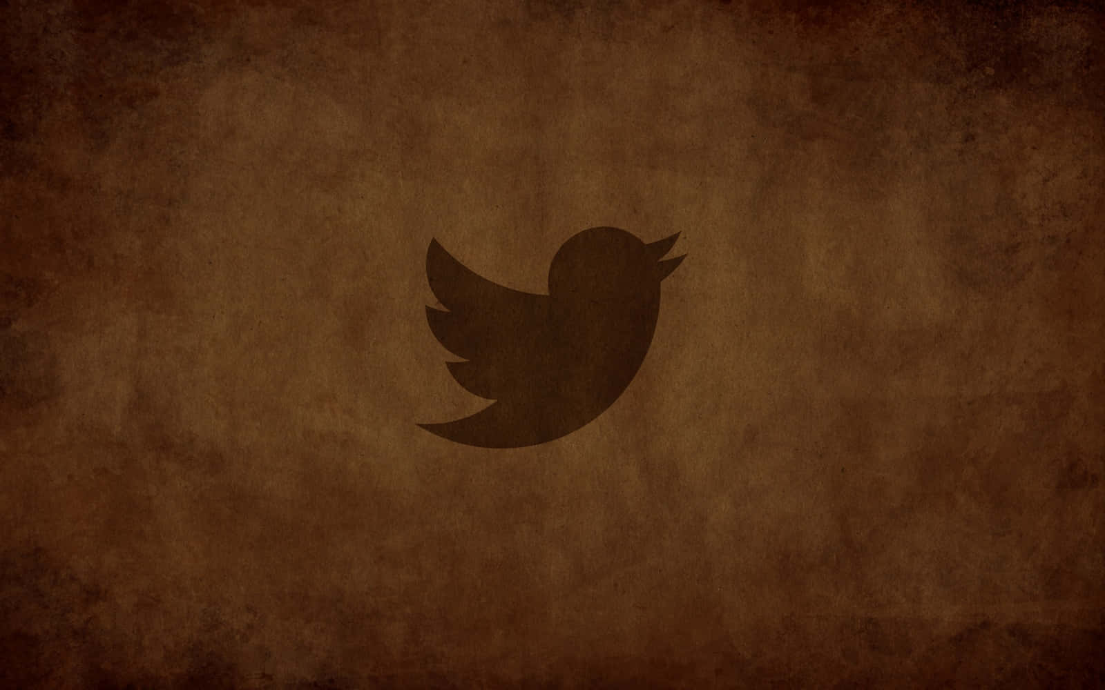 Twitter 桌布 壁紙 — 一個深色鳥類標誌居中於有紋理的棕色復古背景上。