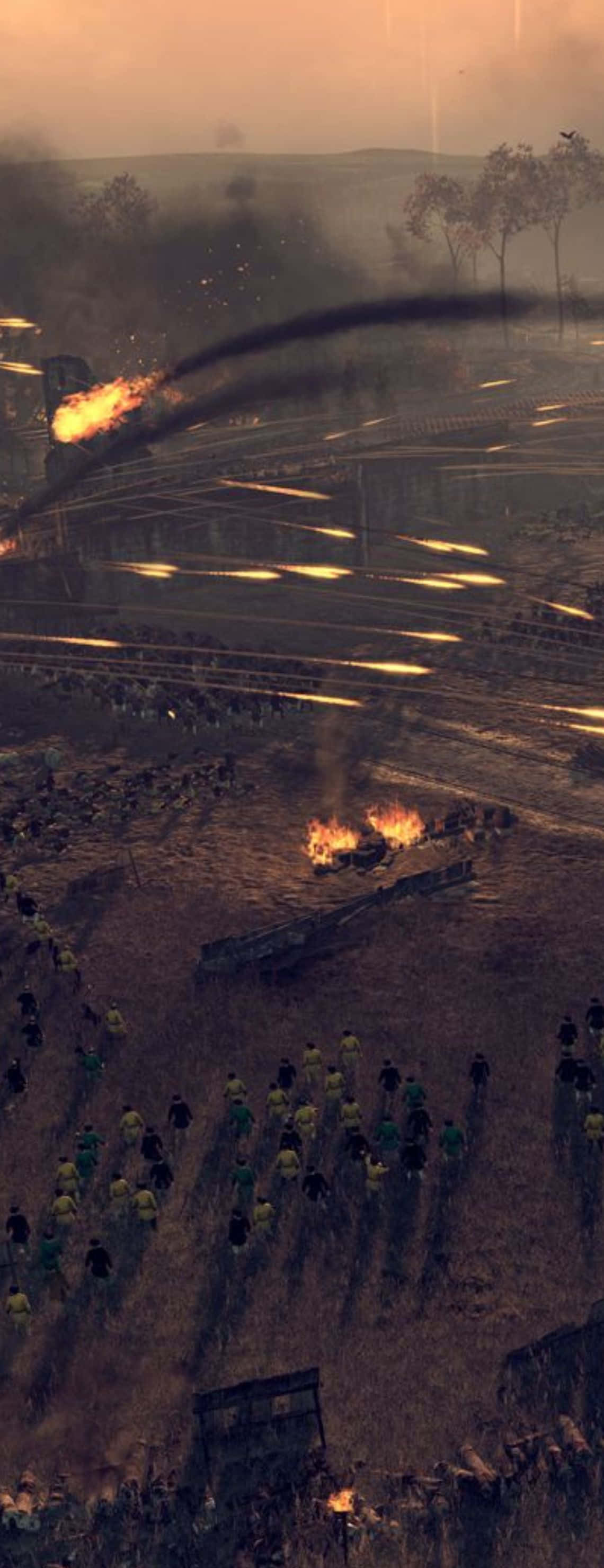 Pixel 3xl Total War Attila 桌布 壁紙 — 一個混亂的戰場，士兵在煙霧和火焰中前進，天空是朦朧的橙色。