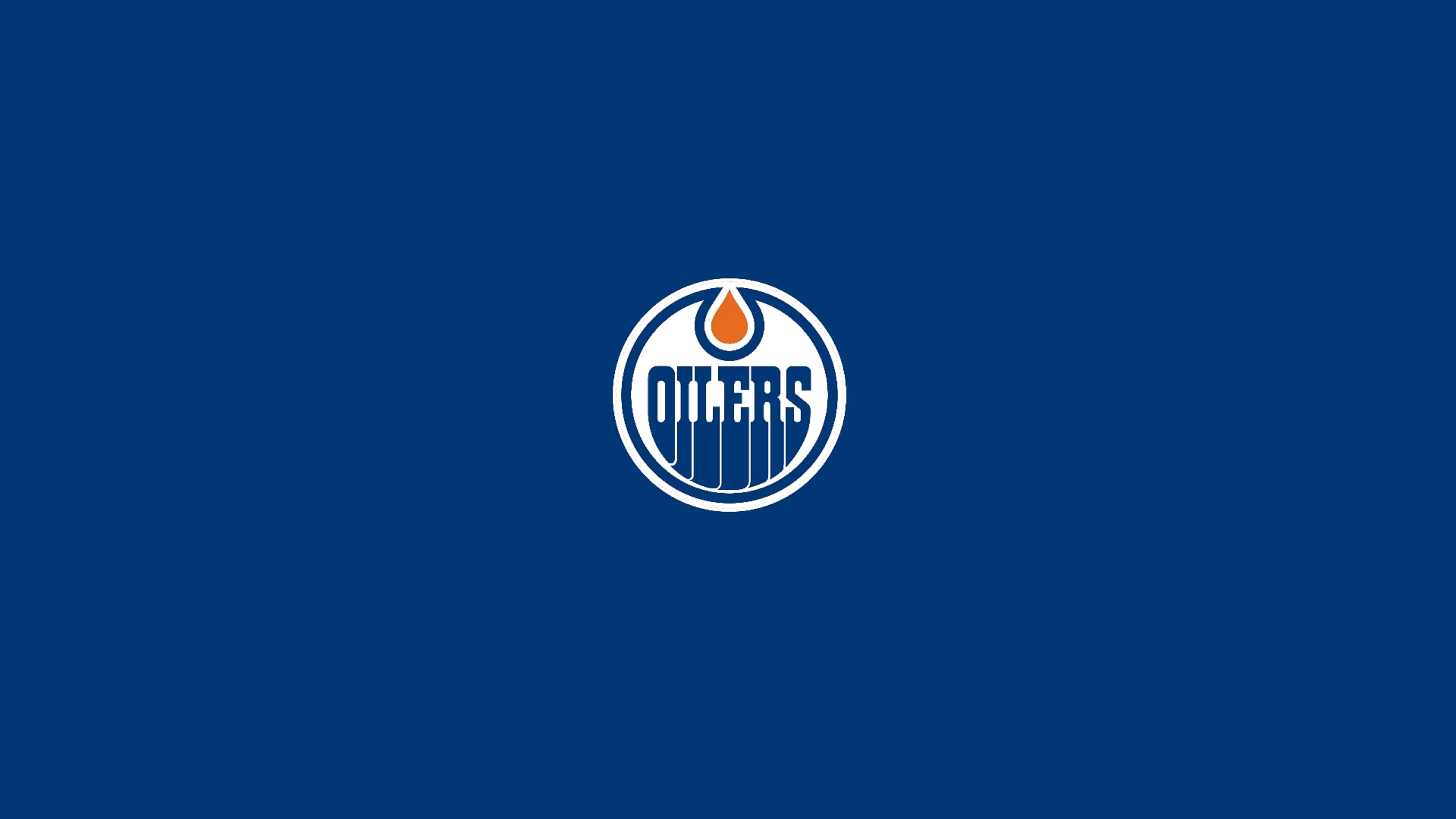 Oilers 桌布 壁紙 — 一個清晰的愛德蒙頓油人隊標誌，居中放置在純皇家藍色背景上。