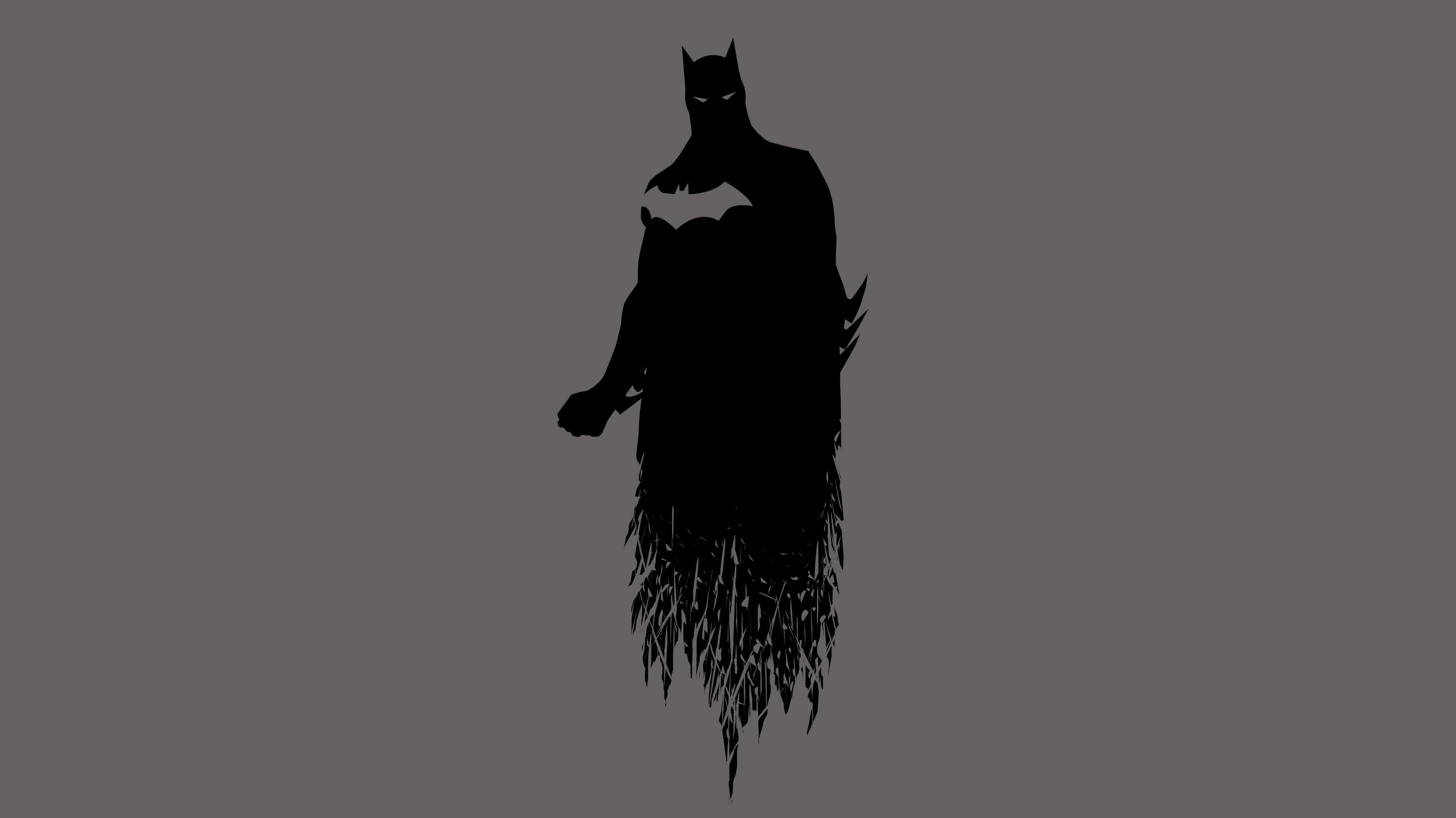 Batman Desktop 桌布 壁紙 — 一個清晰的黑色蝙蝠俠剪影，披風向下飄揚，站在純灰色背景前。