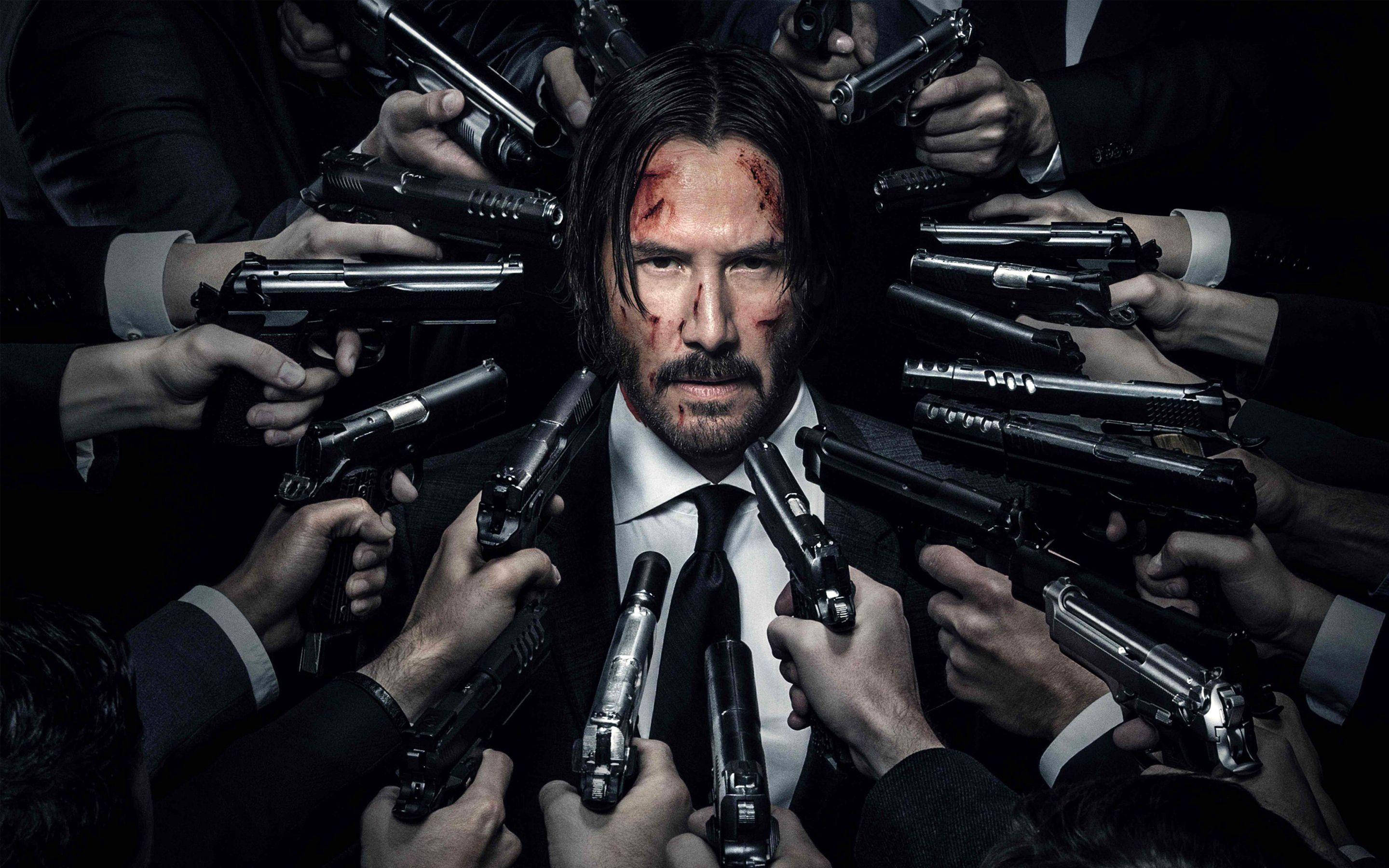 John Wick 桌布 壁紙 — 一個滿臉鮮血的男人，被無數手持槍械的手包圍在黑暗激烈的場景中。