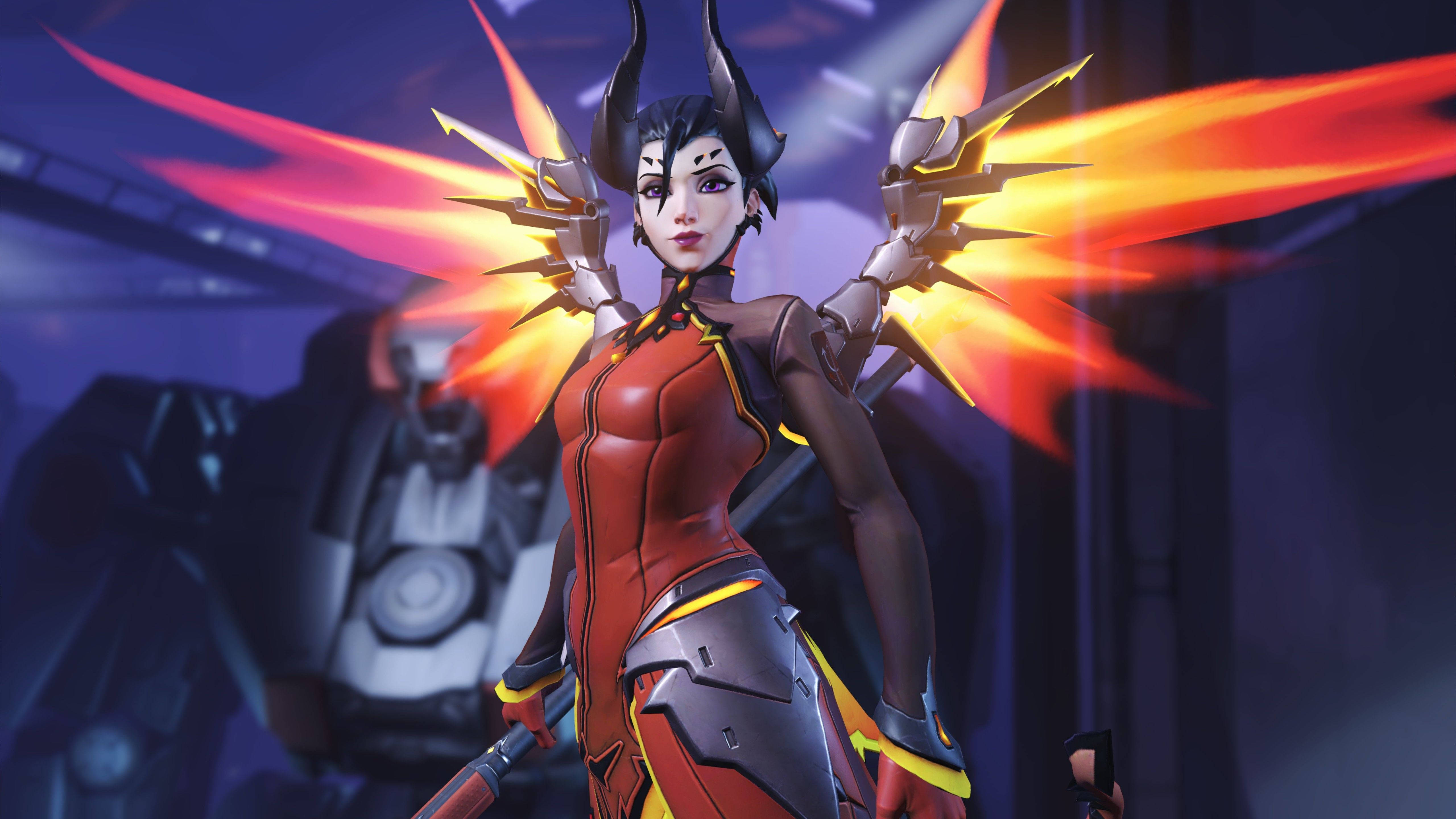 Mercy 桌布 壁紙 — 一個火熱的動漫戰士，擁有發光的翅膀和機械手臂，在黑暗的未來背景前擺好姿勢。