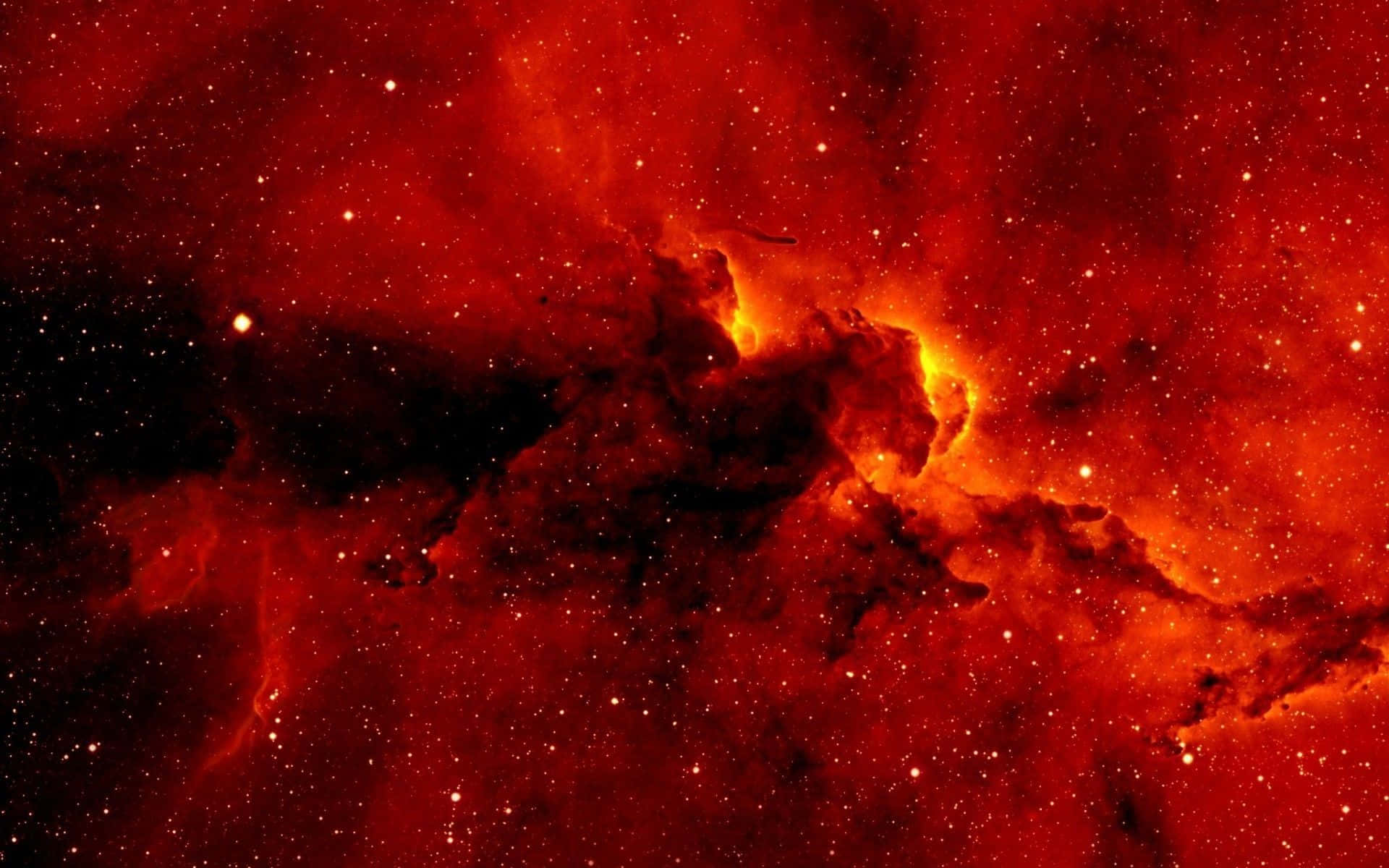 Red Space 桌布 壁紙 — 一個火紅色的星雲，帶有發光的橙色核心和散落的星星，充滿了宇宙虛空。
