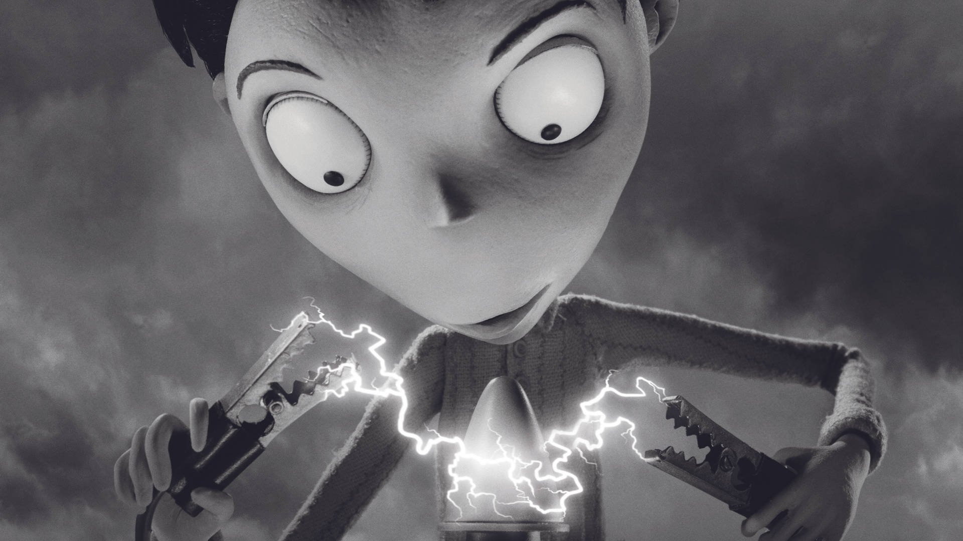 Frankenweenie 桌布 壁紙 — 一個灰色調、睜大眼睛的動畫男孩，在暴風雨的天空下拿著鉗子，鉗子之間迸發出電火花。