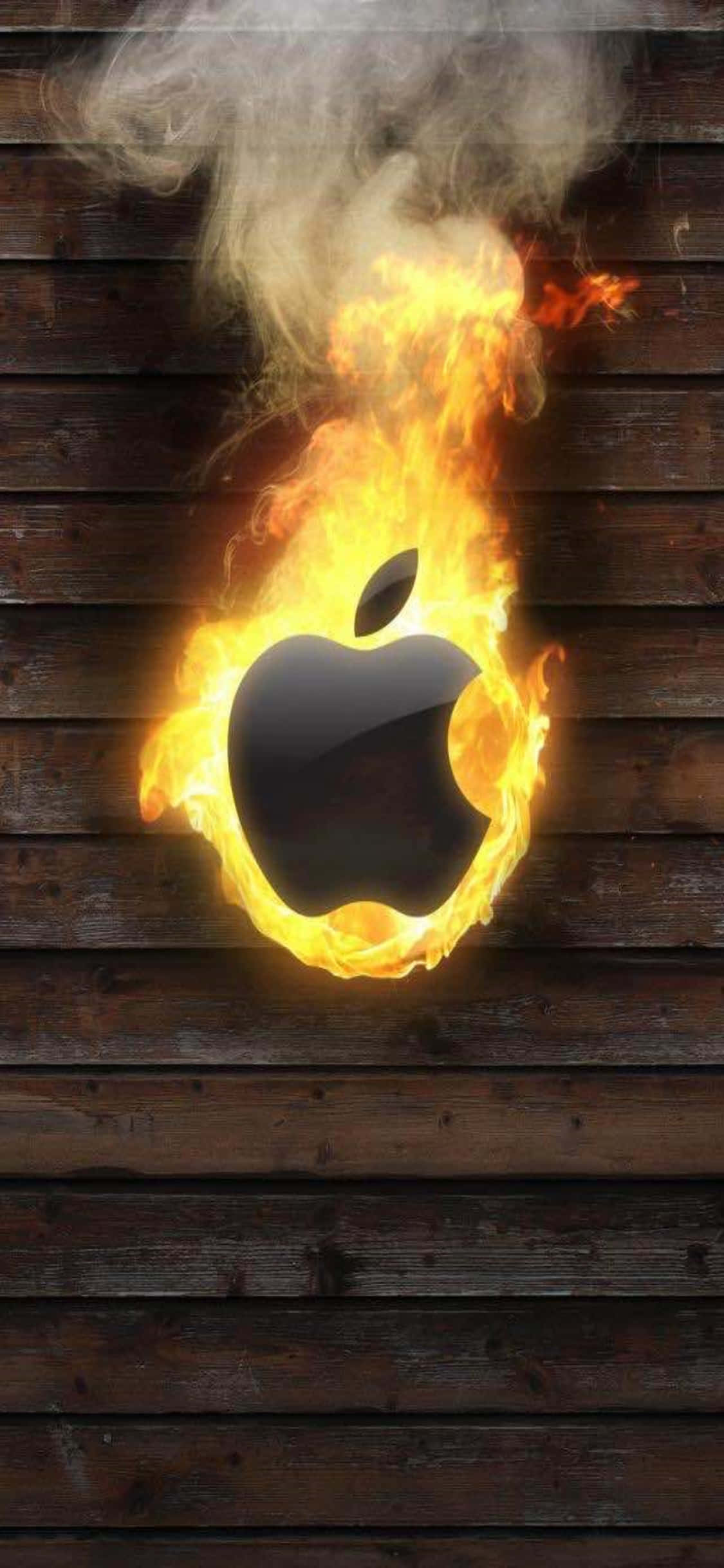 iPhone 11 桌布 壁紙 — 一個燃燒的Apple標誌在深色木板上猛烈燃燒，煙霧升騰。