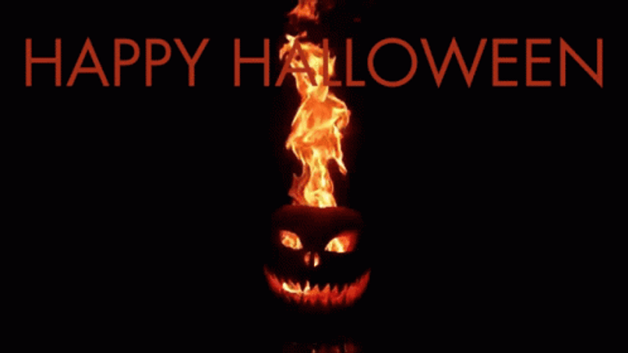 Spooky 桌布 壁紙 — 一個燃燒的傑克南瓜燈，帶有發光的眼睛和牙齒，背景為黑色，帶有橙色「HAPPY HALLOWEEN」文字。