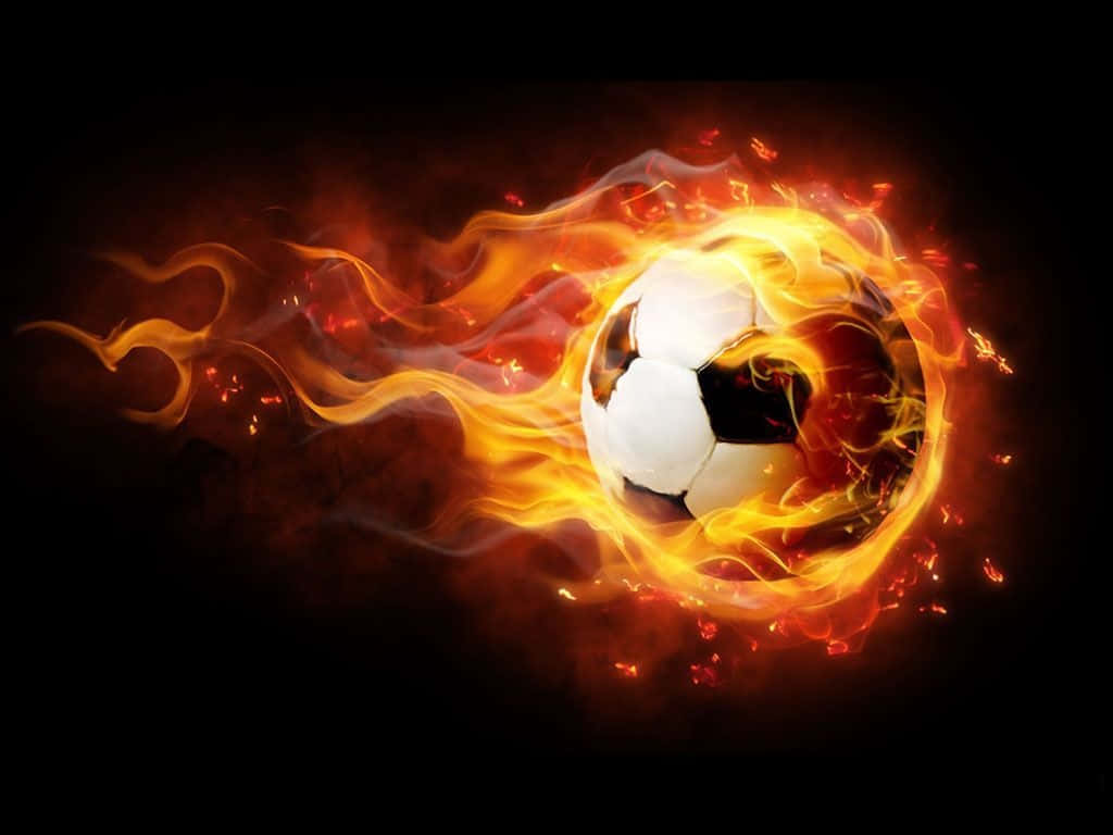 Football On Fire 桌布 壁紙 — 一個燃燒的足球劃過黑暗，身後拖曳著鮮豔的橙色和黃色火焰。