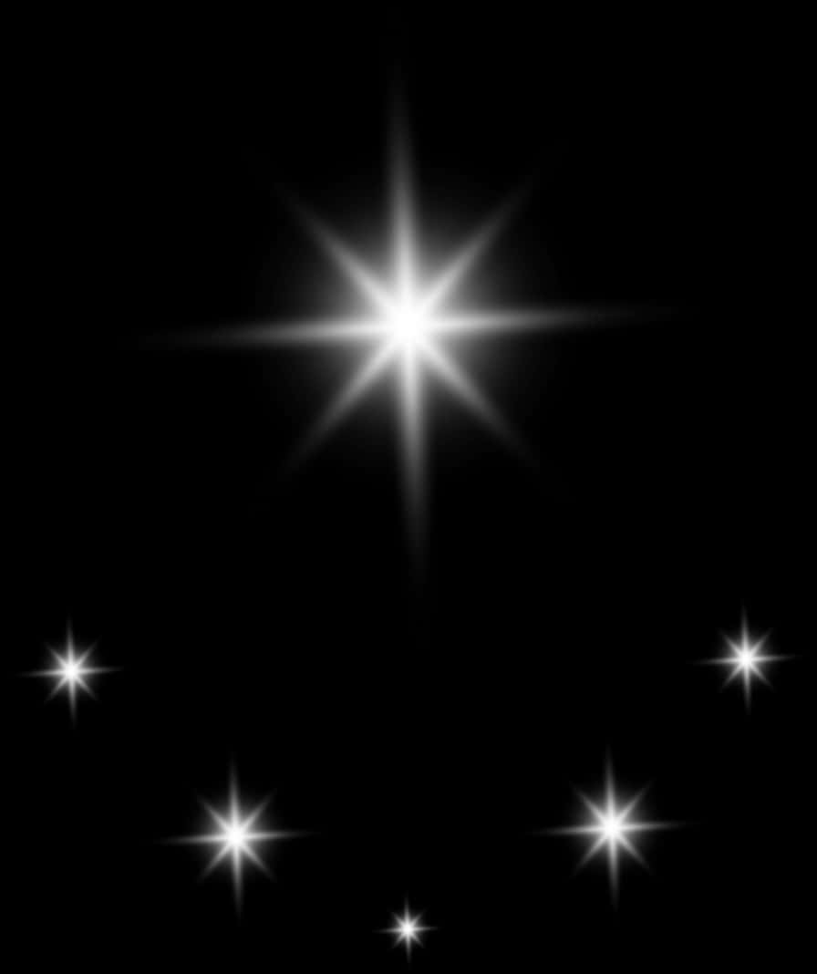 Stars 桌布 壁紙 — 一個燦爛的星爆在深邃的黑色虛空中明亮閃耀，周圍散佈著較小的星星。