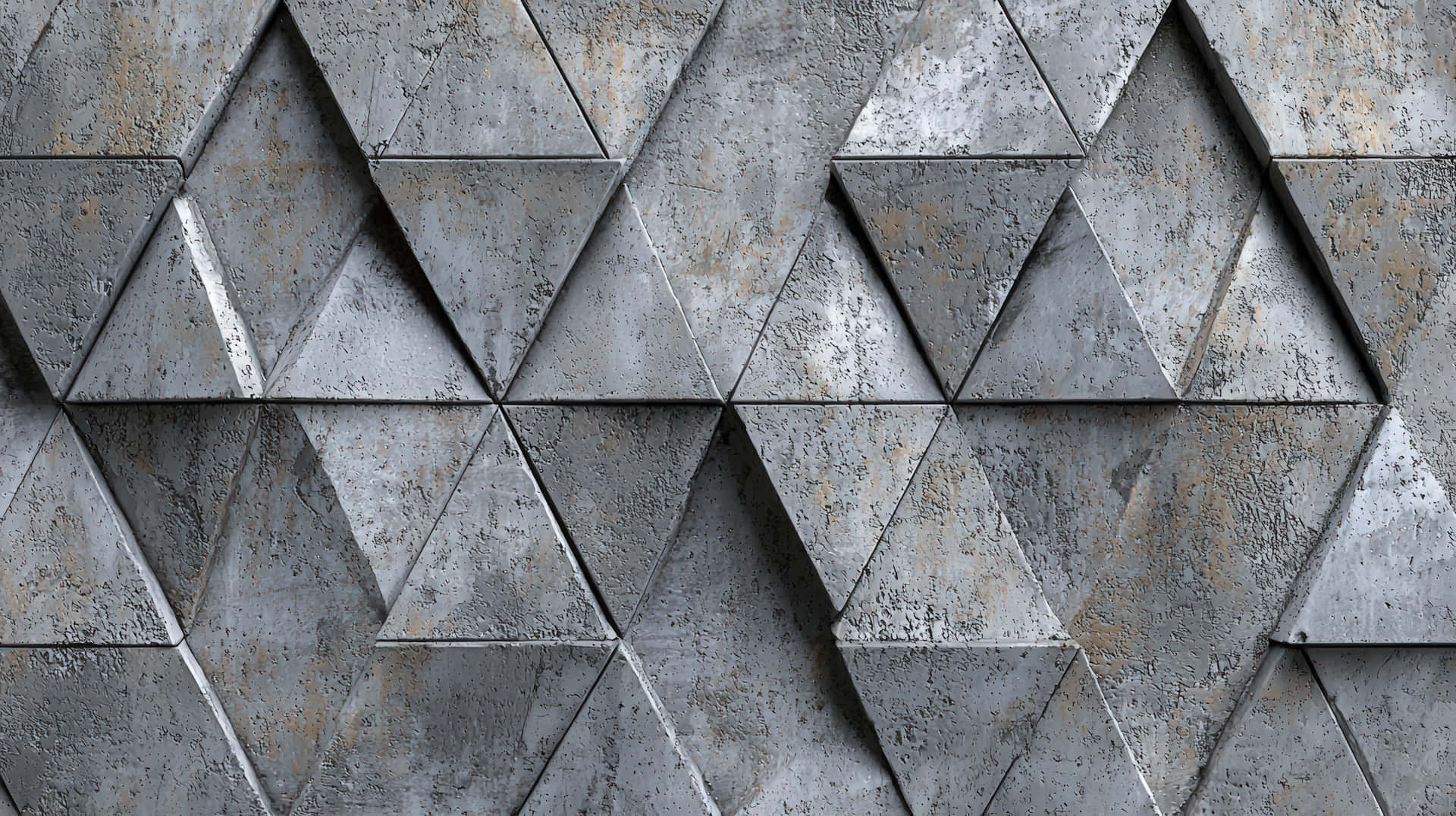 Abstract metallic surface with a repeating pattern of raised and textured triangular shapes 壁紙 — 一個特寫的紋理金屬牆，由相互連接的三角形面板組成，帶有風化的灰色和鏽跡點綴。