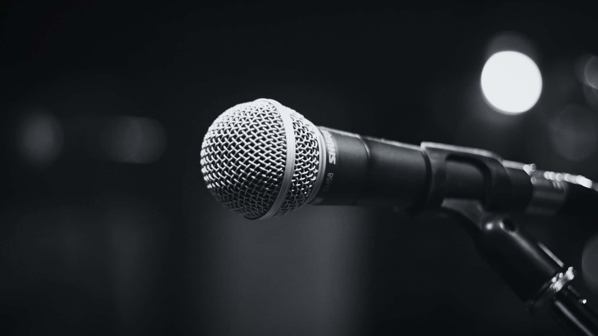 Black And White Music 桌布 壁紙 — 一個特寫黑白鏡頭，拍攝支架上的麥克風，背景有明亮的散景光。