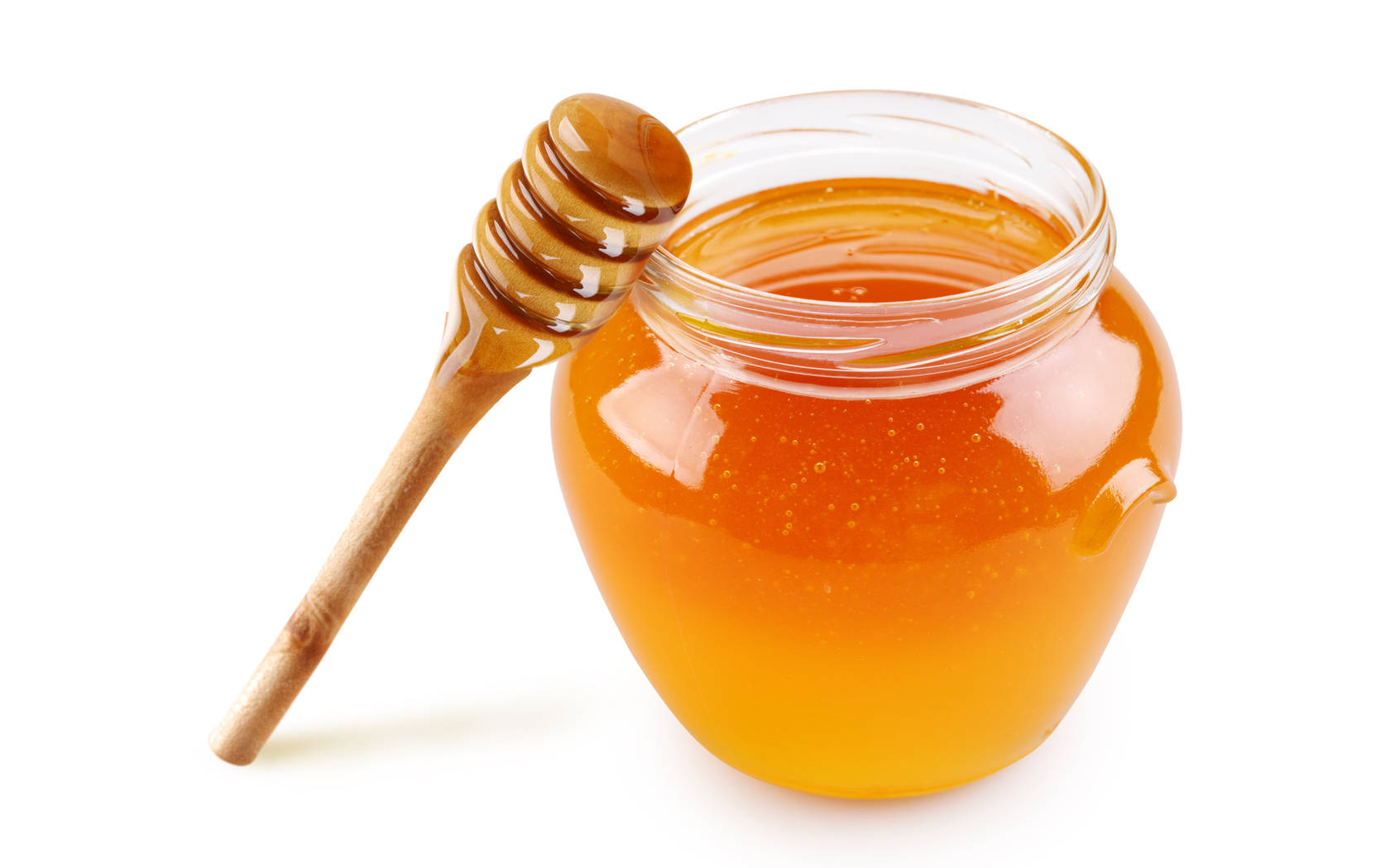 Honeycomb 桌布 壁紙 — 一個玻璃罐裝滿金黃色蜂蜜，配以木製蘸棒靠在白色背景上。