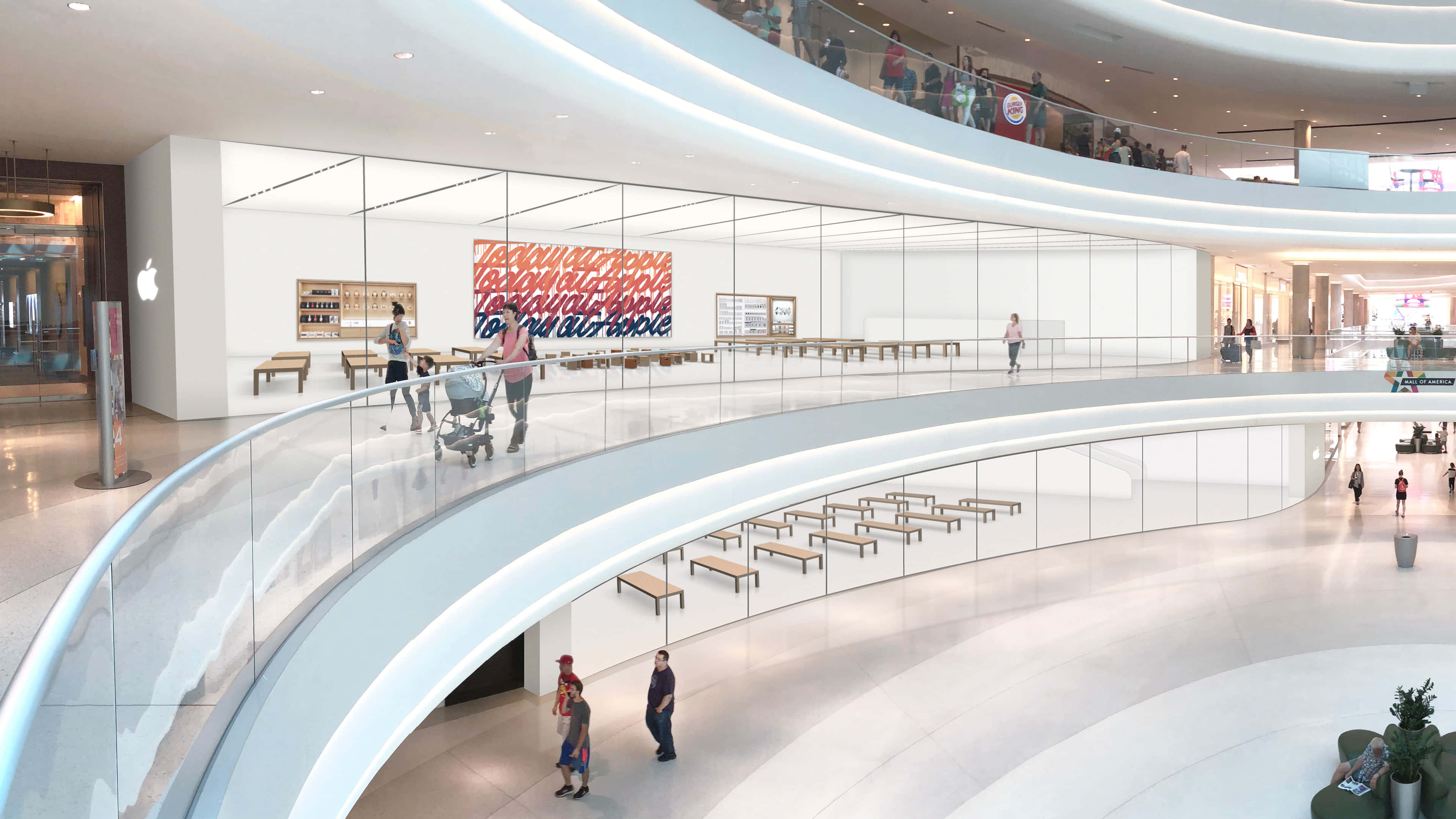 Mall Of America 桌布 壁紙 — 一個現代化的多層購物中心，設有弧形玻璃欄杆，購物者經過 Apple 商店。