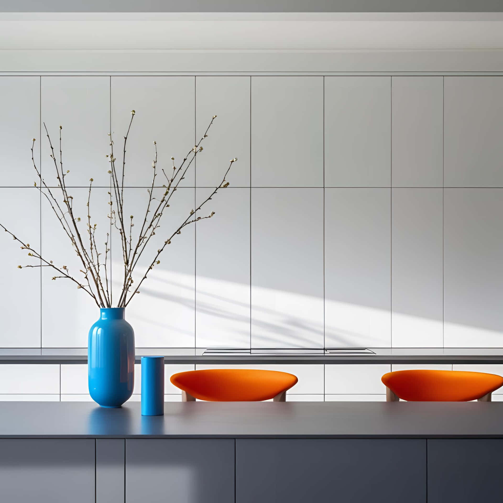 A modern kitchen with blue vases, orange stools, and white cabinets in a minimalist design style 壁紙 — 一個現代廚房檯面上放著一個藍色花瓶，插著光禿禿的樹枝，旁邊有兩張橙色椅子，在明亮的陽光下。