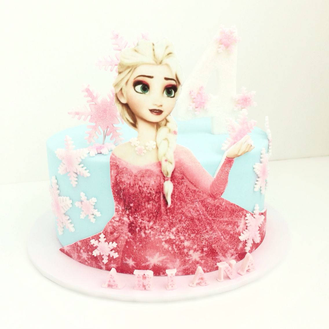 一個帶有《冰雪奇緣》艾莎和名字Atiana的生日蛋糕。 — 冰雪奇緣 GIF 壁紙