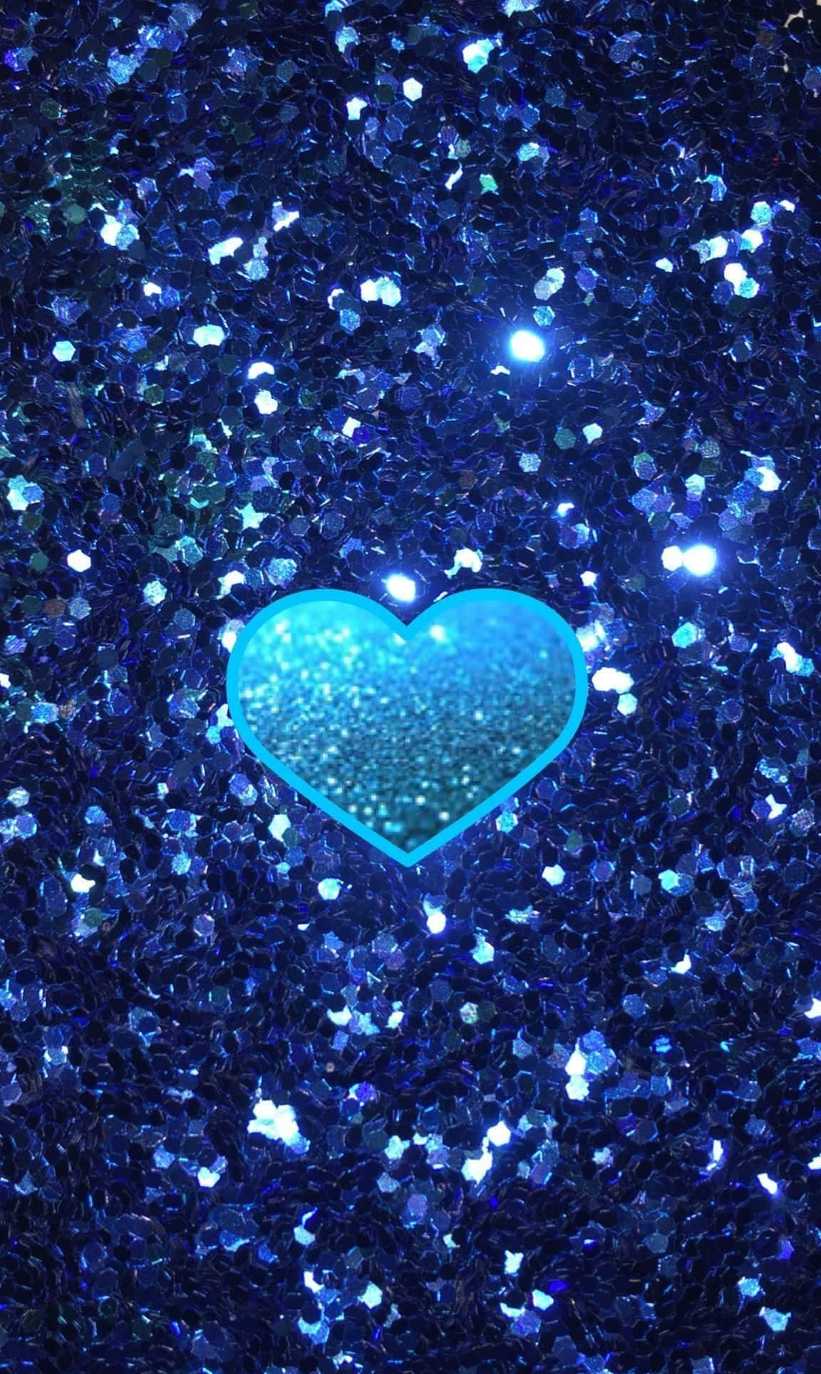 Blue Heart 桌布 壁紙 — 一個由亮粉製成的發光青色心形，放置在閃爍深藍色亮粉的場地上。