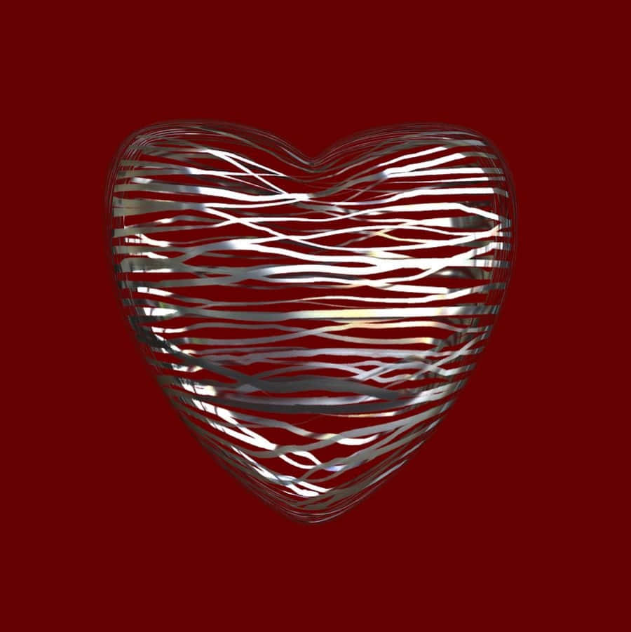 Heart Art 桌布 壁紙 — 一個由反光銀線編織而成的金屬心形雕塑，在深紅色背景上閃耀。