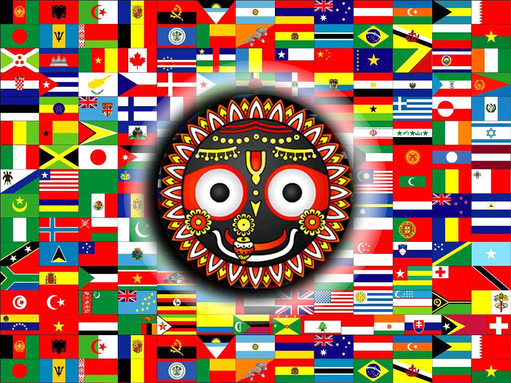 Jagannath 桌布 壁紙 — 一個由各國國旗組成的充滿活力的全球馬賽克，為中央裝飾性的紅黑印度民間藝術面具提供了背景。