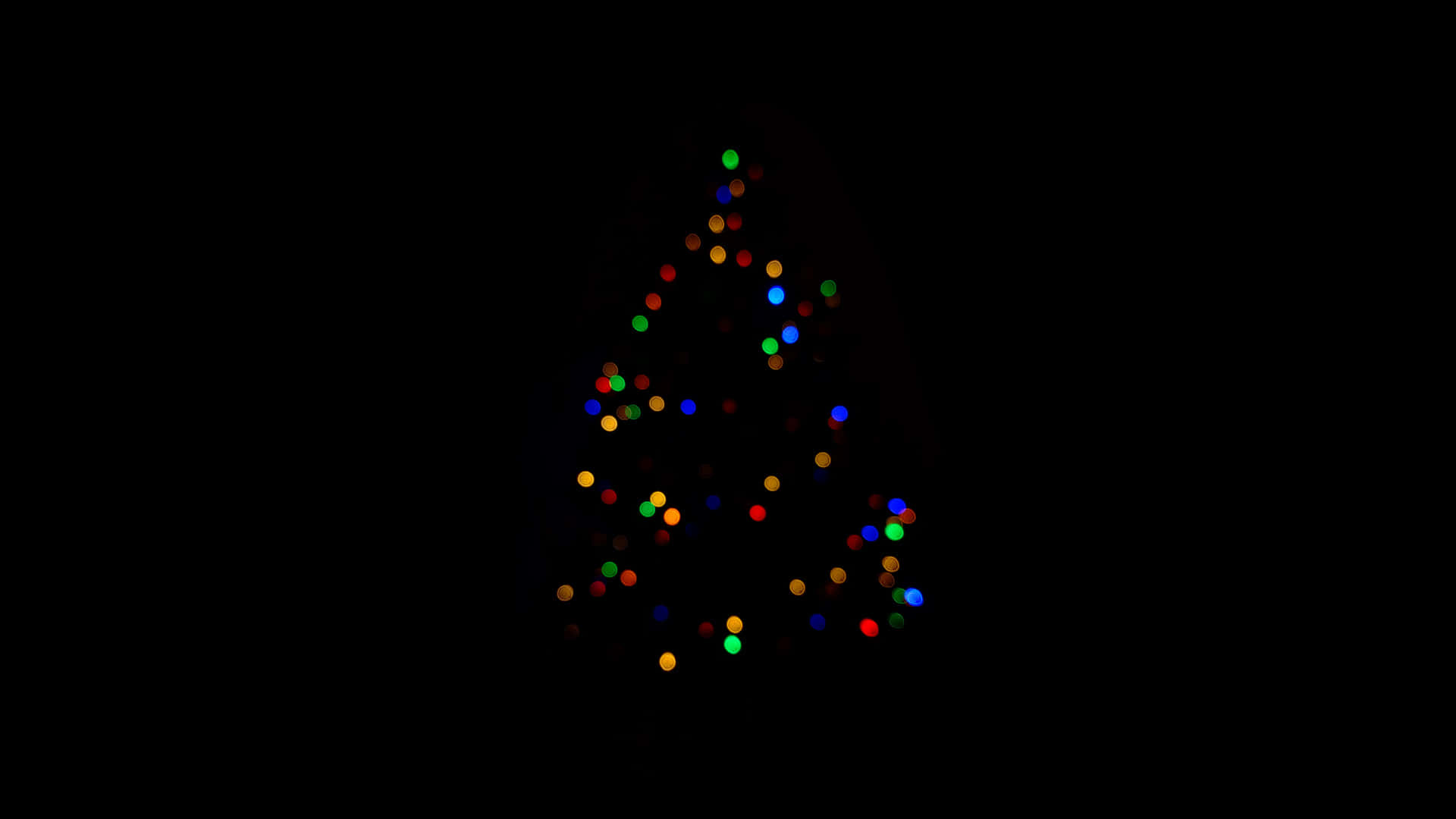 Christmas Lights Aesthetic 桌布 壁紙 — 一個由彩色發光燈光組成的散景聖誕樹，背景為黑色。