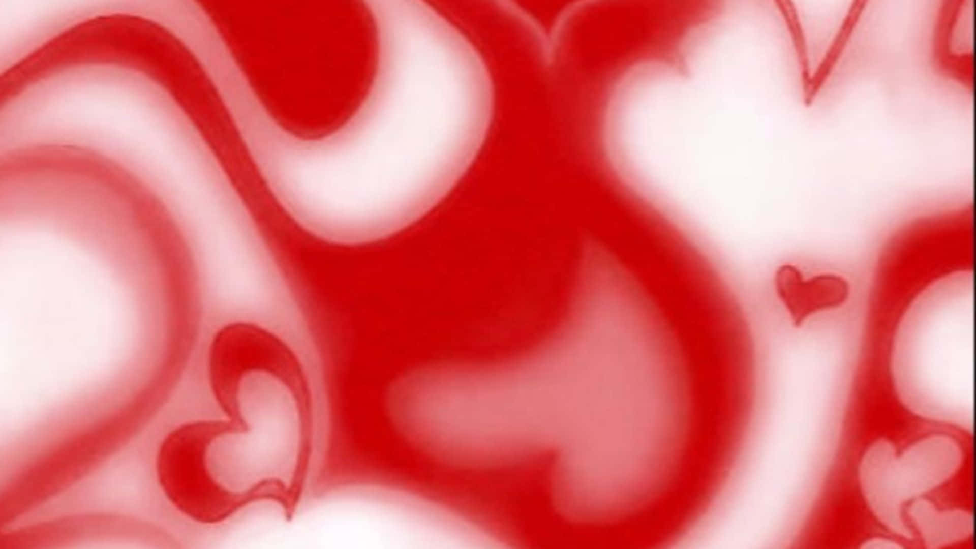 Red Hearts 桌布 壁紙 — 一個由紅色和白色心形組成的流動抽象圖案，帶有柔和漸變和漩渦效果。