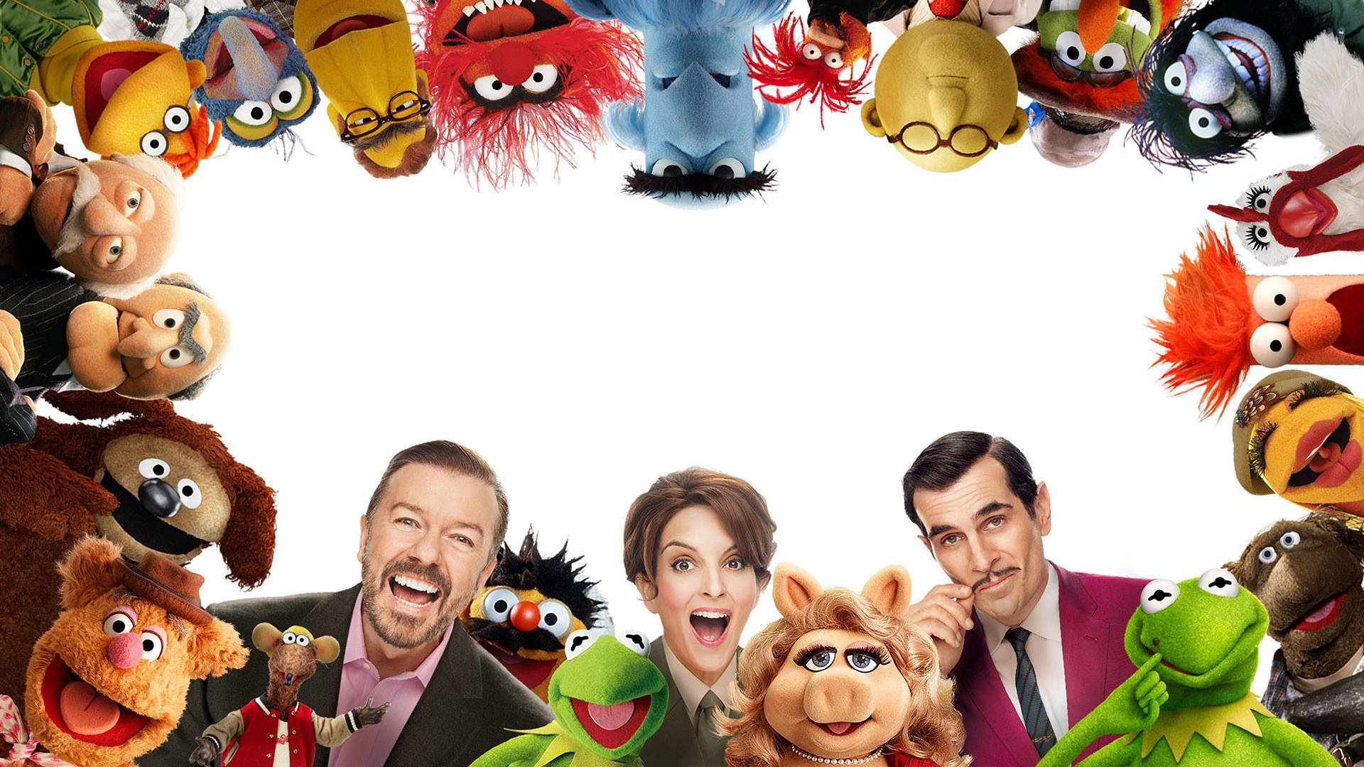 muppets 桌布 壁紙 — 一個由色彩繽紛的Muppet角色組成的快樂圓圈，圍繞著三位微笑的人類演員，背景是純白色。